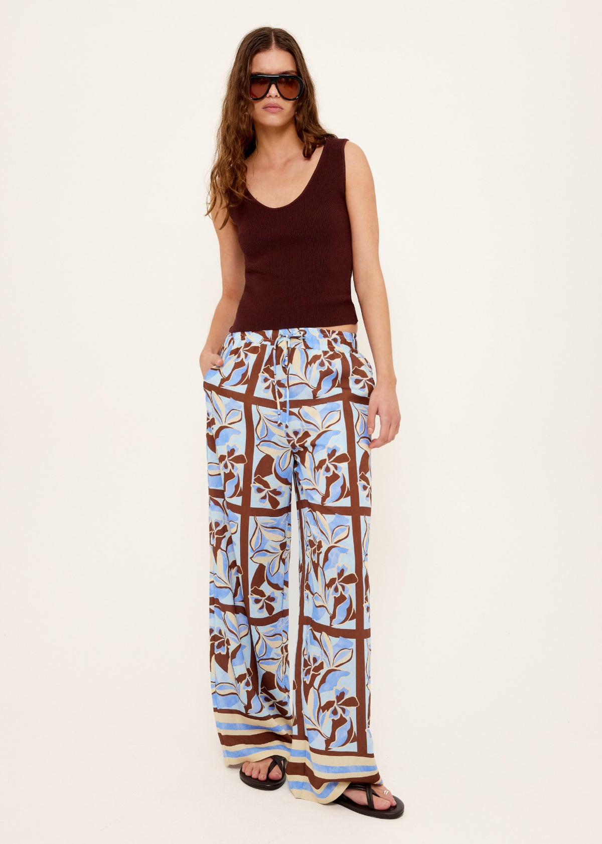 Model wearing Chocolate Brown Reversible Knit Tank Top with a reversible design: wear and a fitted rib knit silhouette.