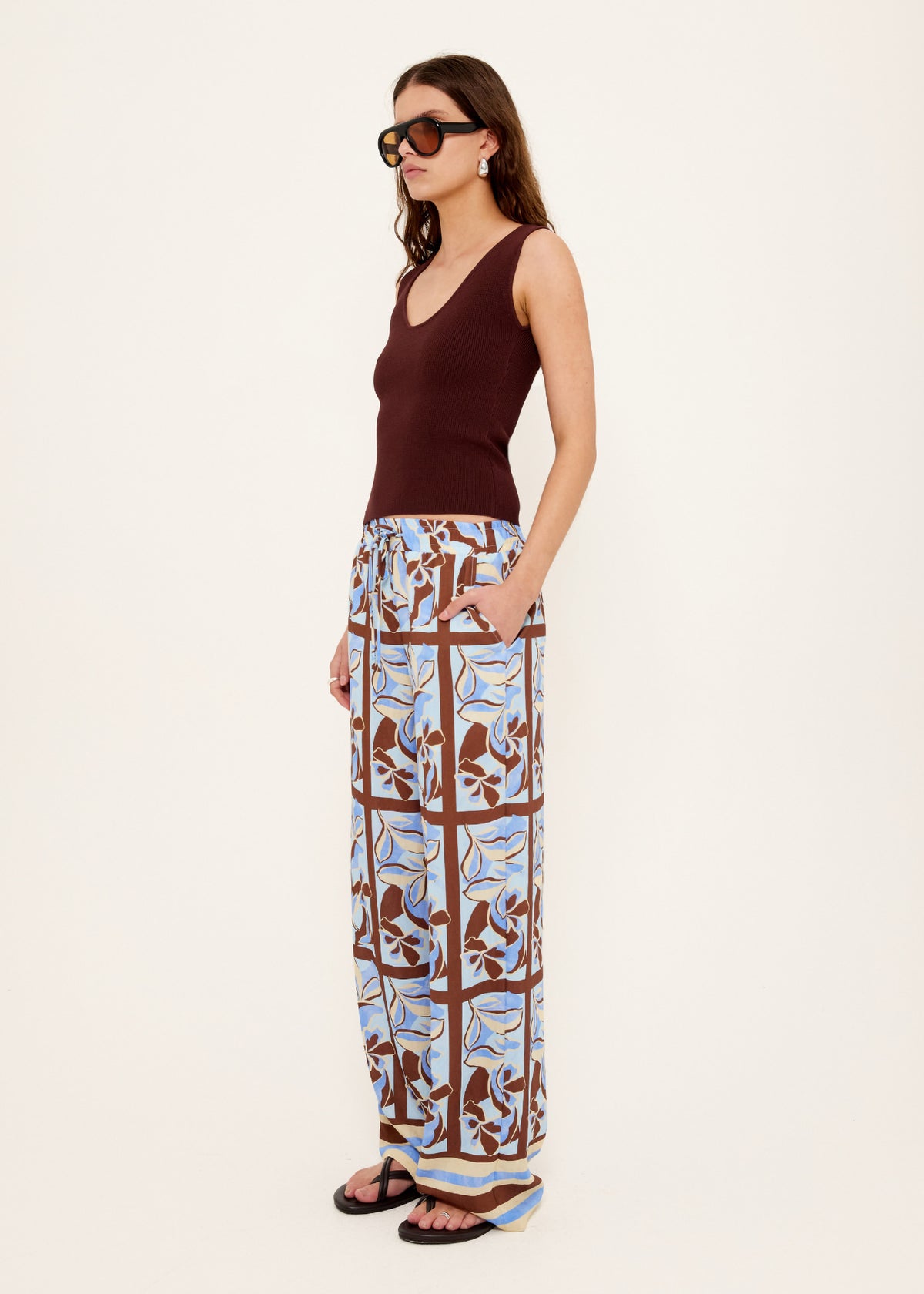 Model wearing Chocolate Brown Reversible Knit Tank Top with a reversible design: wear and a fitted rib knit silhouette, turned to the side.