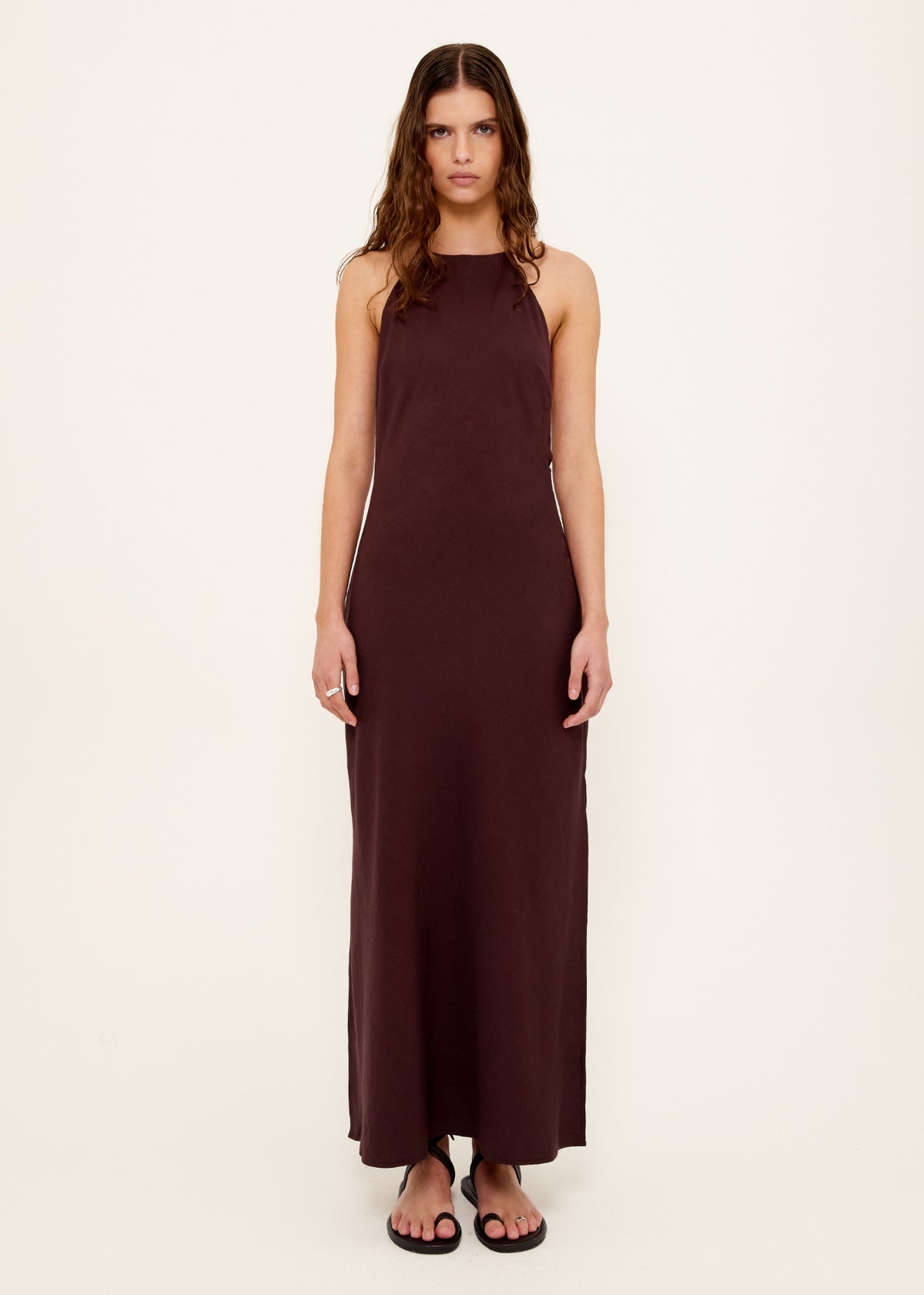 Model wearing Chocolate Halter Midi Dress with a halter neckline with adjustable tie back and an open back with strap detail.