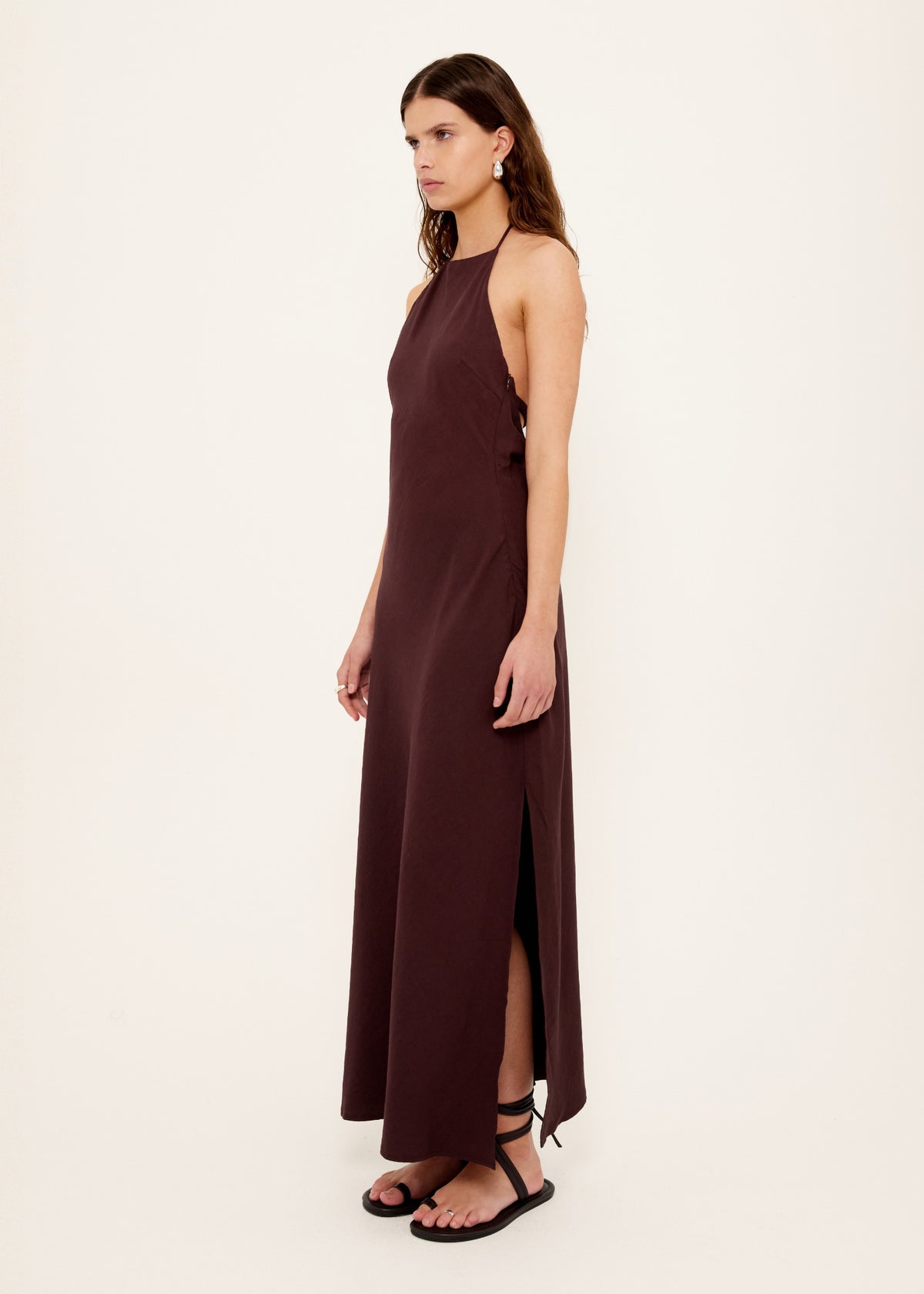 Model wearing Chocolate Halter Midi Dress, showing a fully lined and a halter neckline with adjustable tie back.