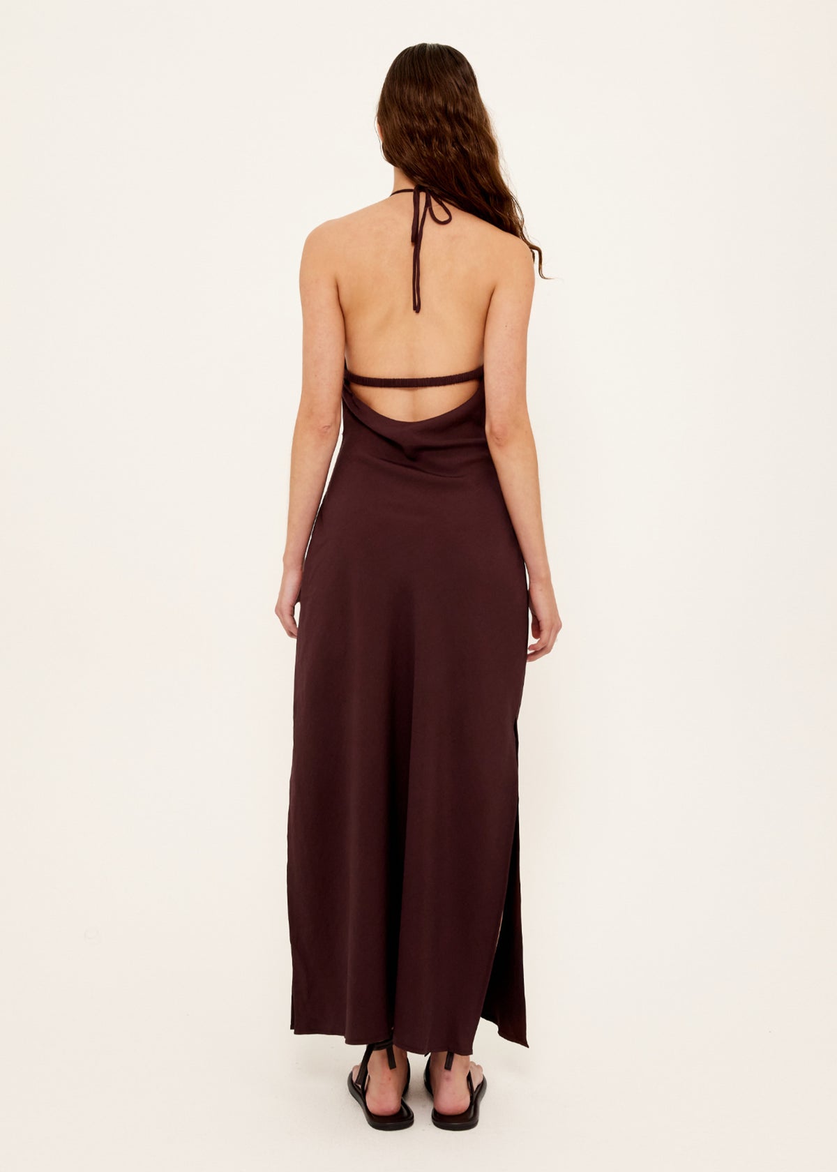 Back view of the Chocolate Halter Midi Dress with a halter neckline with adjustable tie back and an open back with strap detail.