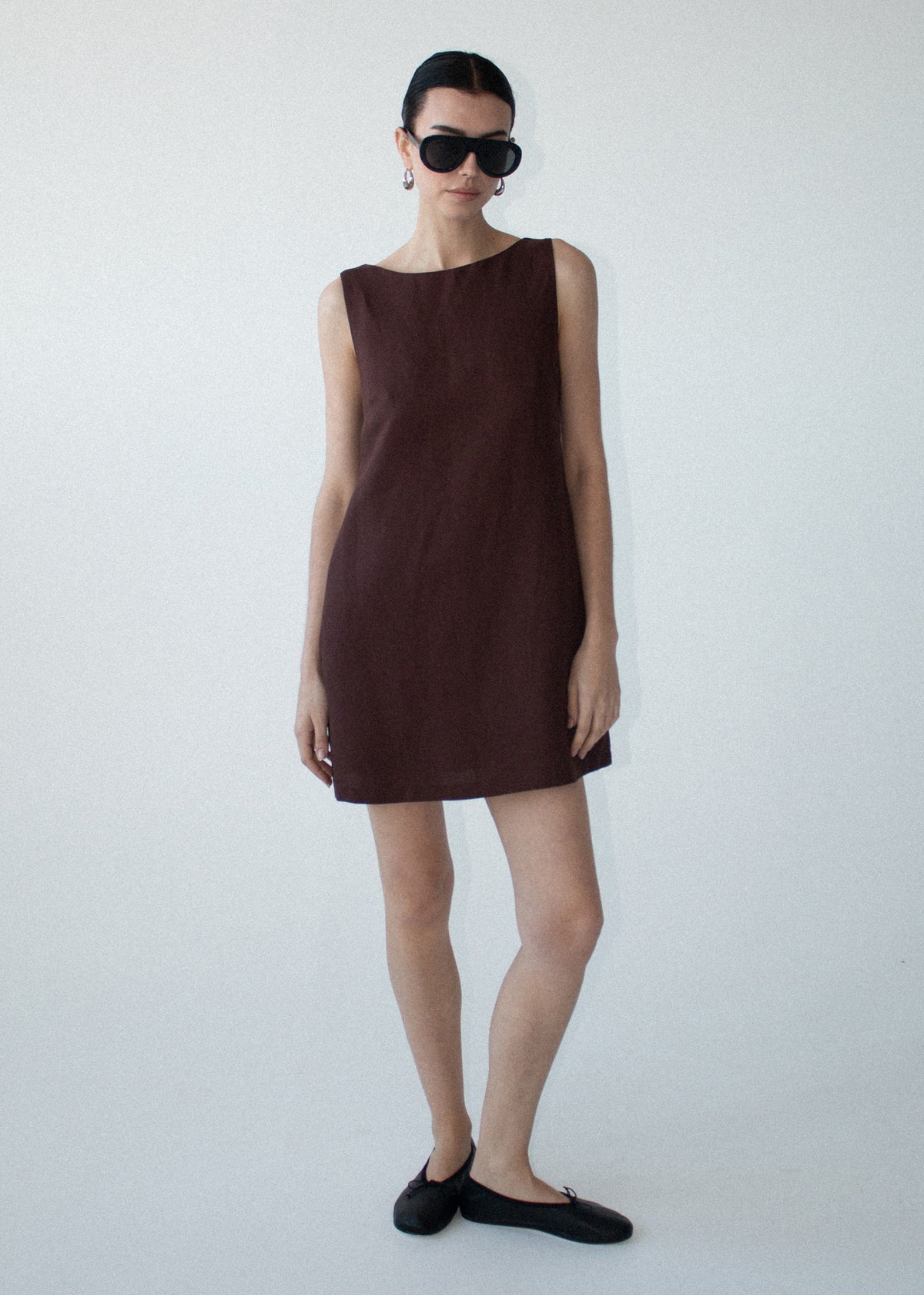 Model wearing Chocolate Linen Blend Boat Neck Mini Shift Dress with side pockets and a mini length.