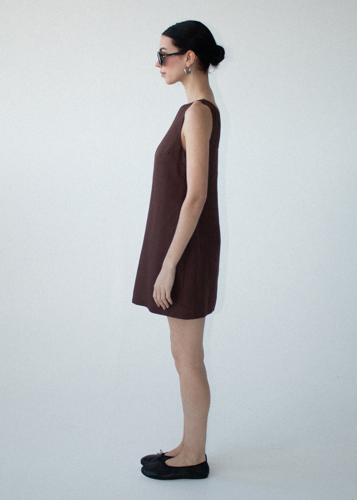 Side view of the Chocolate Linen Blend Boat Neck Mini Shift Dress, showing a lightweight linen fabrication and a high boat neckline.