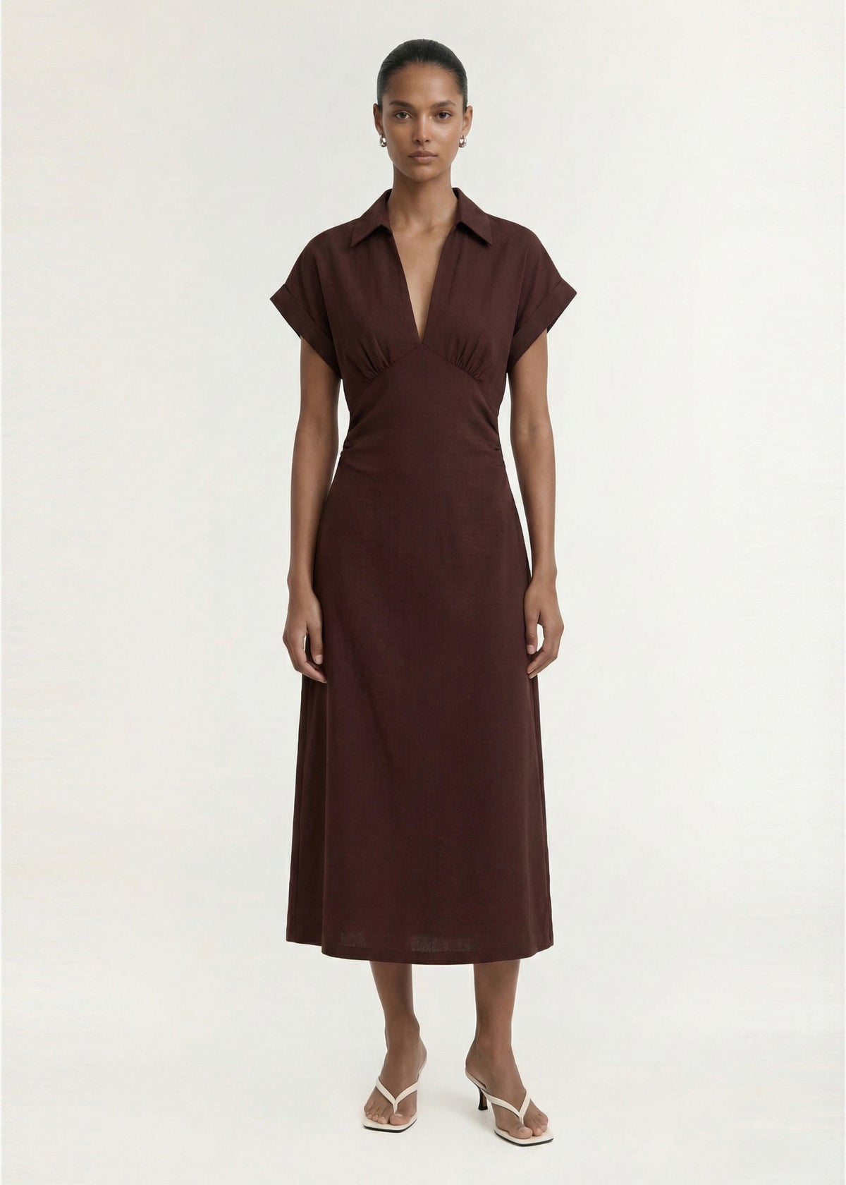 Model wearing Chocolate Linen Blend Collared Midi Dress with a lightweight woven fabrication and a collared V-neckline.