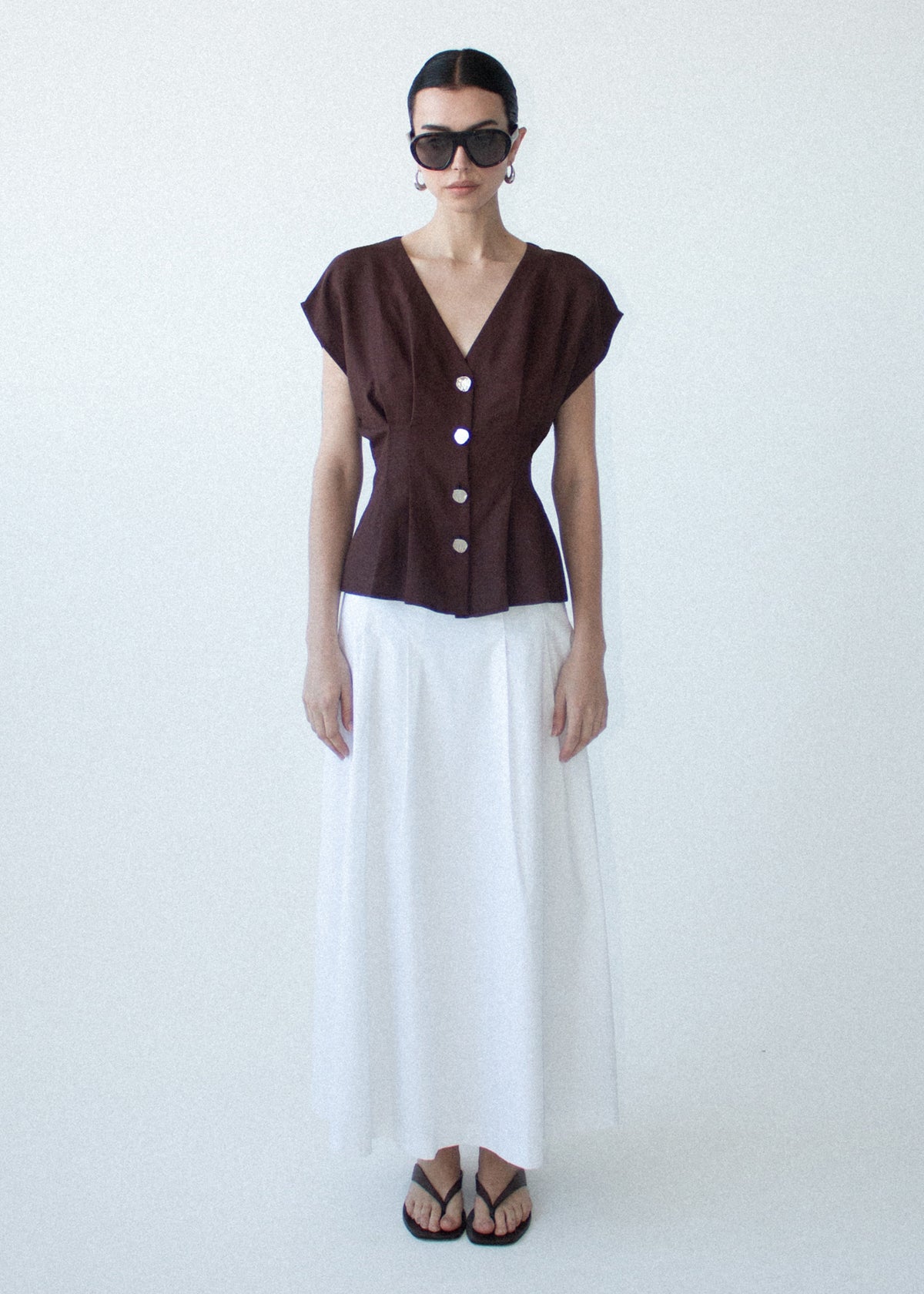 Model wearing Chocolate Linen Blend V-Neck Cropped Top, showing a fitted, waist-defined silhouette and a cropped length.