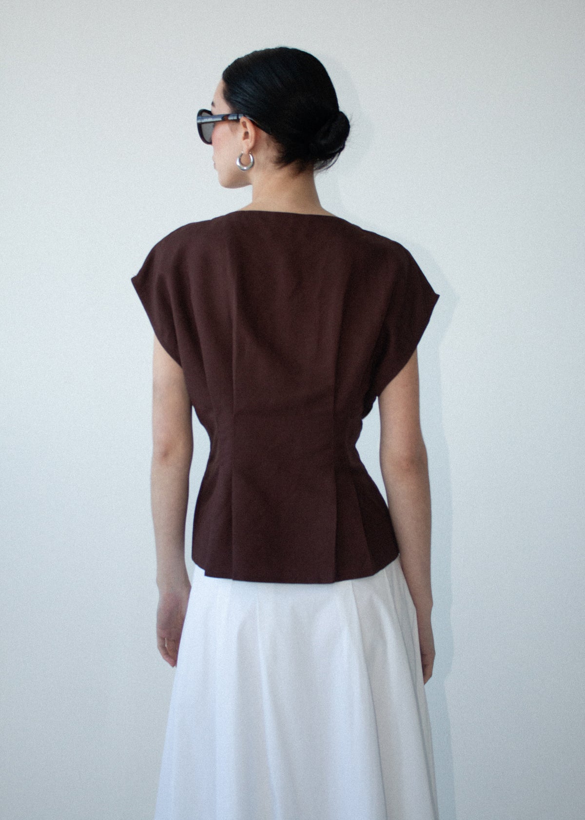 Back view of the Chocolate Linen Blend V-Neck Cropped Top with a button-through front and a lightweight linen fabrication.