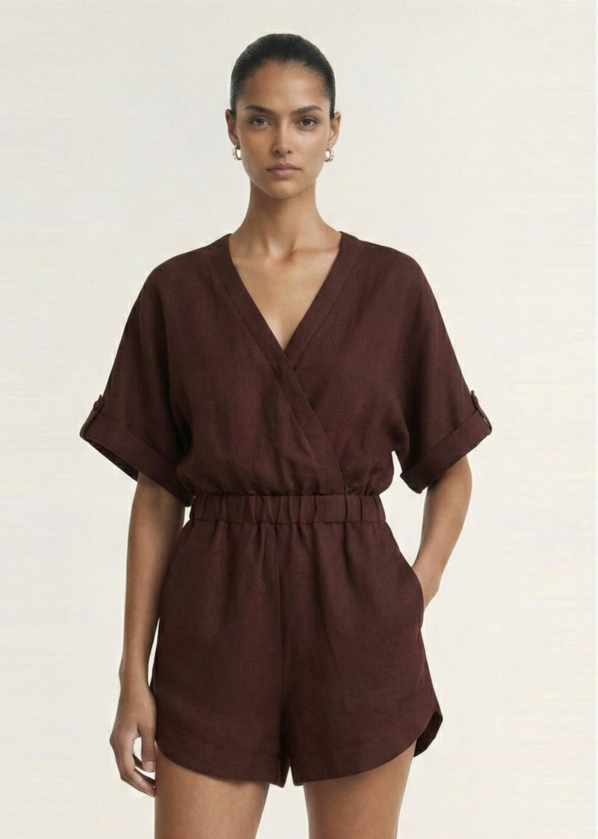 Close-up of the Chocolate Linen Blend Wrap Playsuit, showing a wrap-style V-neckline and a dolman sleeves with tab detail.