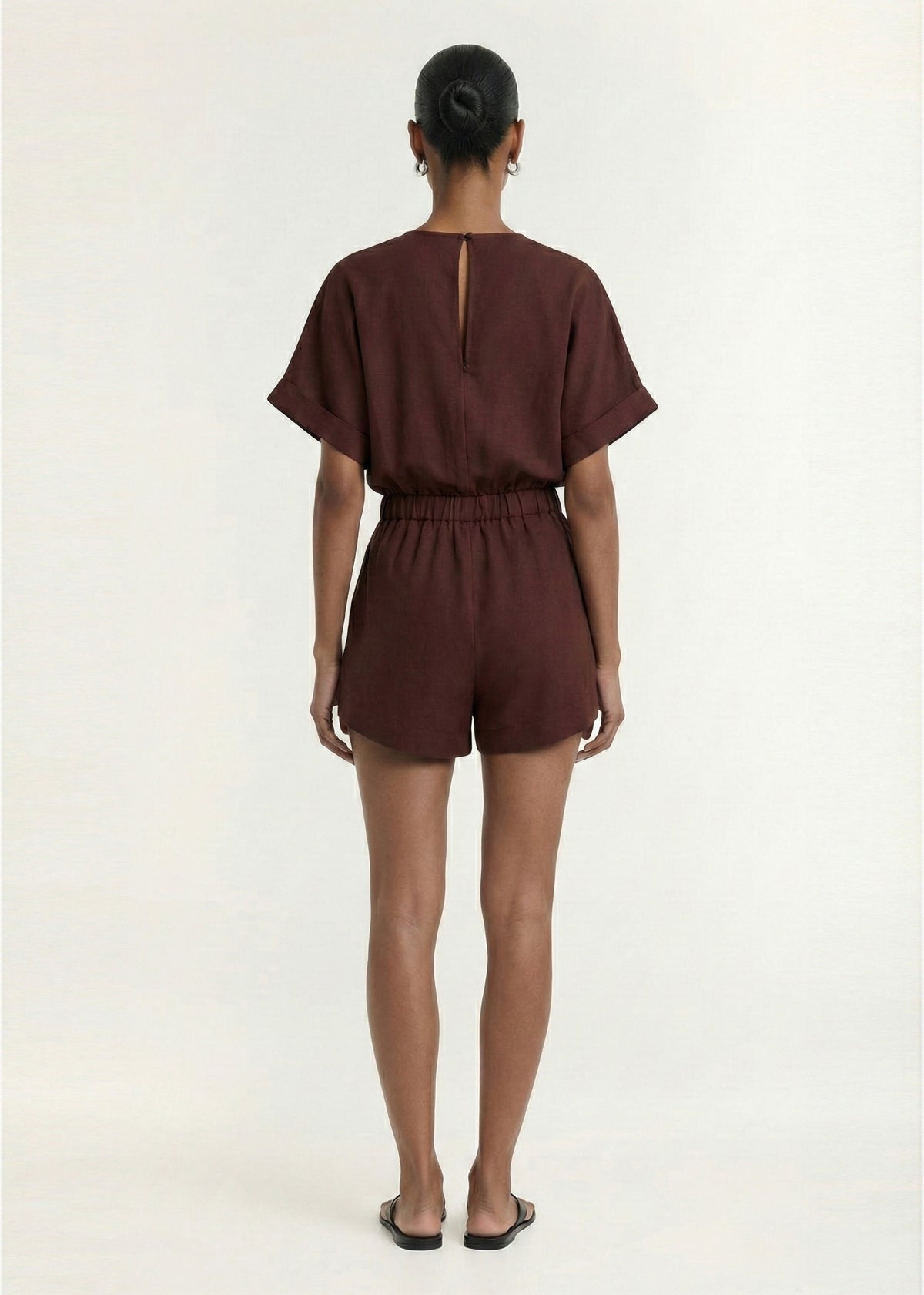 Back view of the Chocolate Linen Blend Wrap Playsuit, showing a lightweight linen fabrication and a wrap-style V-neckline.
