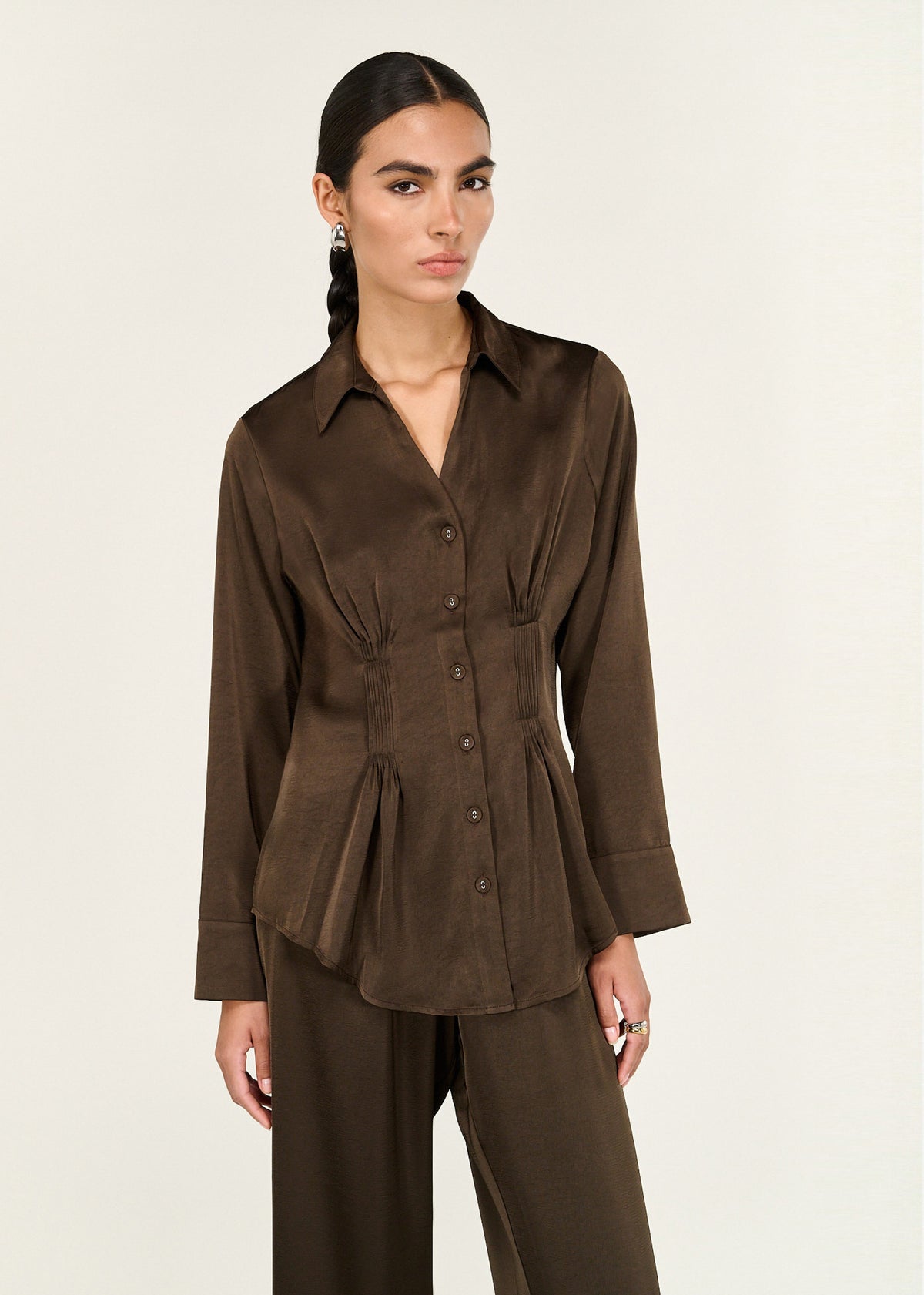 Close-up of the Chocolate Pintuck Cinched Waist Satin Shirt, showing a full button-through front and a classic collar.