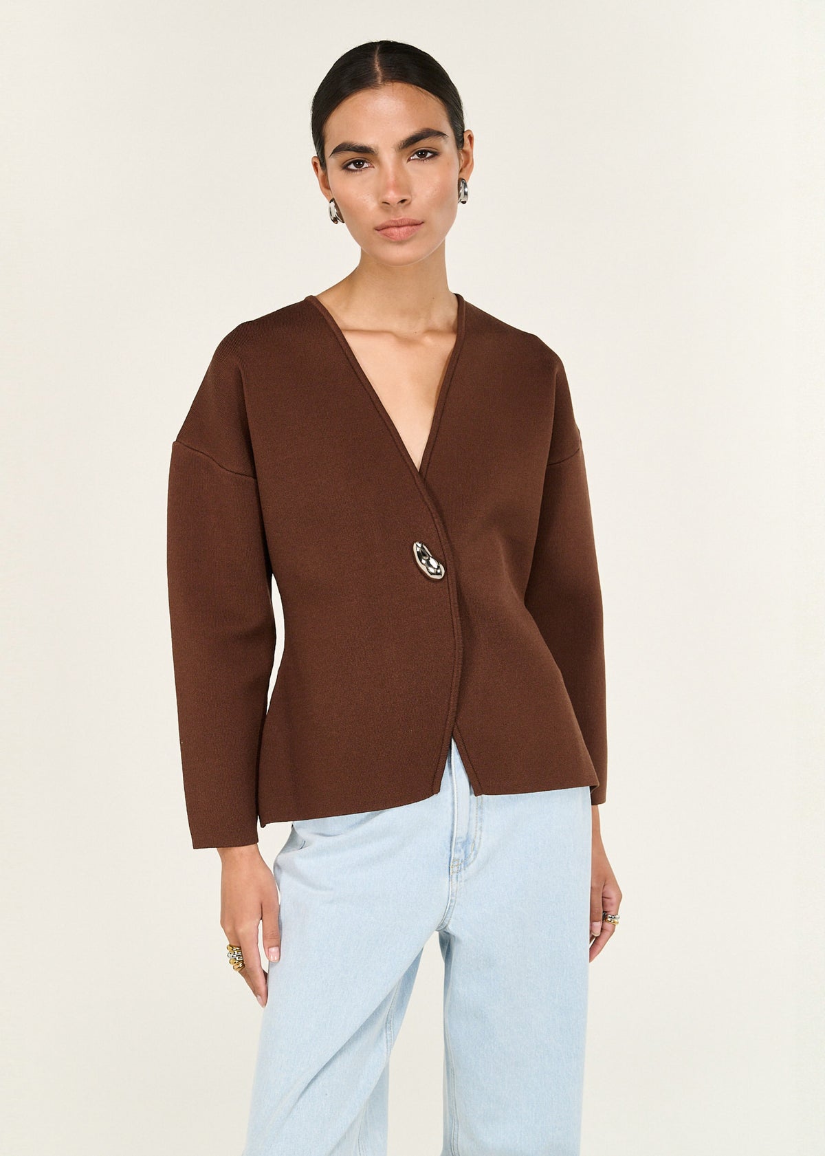 Close-up of the Chocolate Sculptured Soft Cardigan with Hardware Detail, showing an asymmetrical button closure and a deep V neckline.