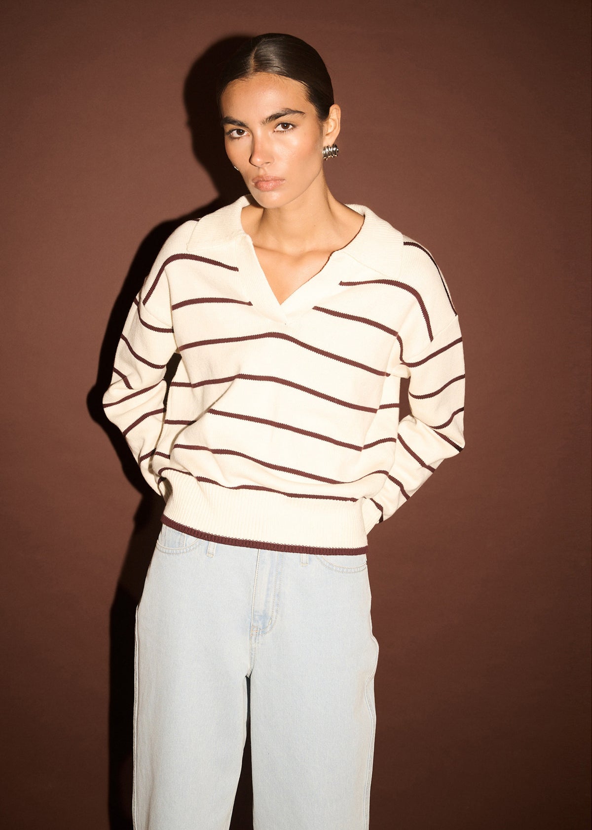 Close-up of the Chocolate Stripe Polo Knit Jumper, showing an open polo neckline and dropped shoulders.