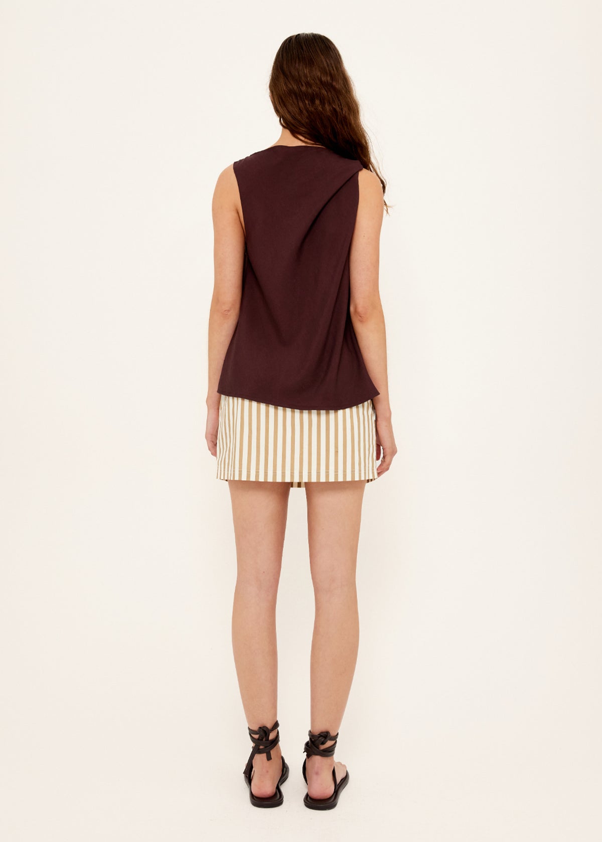 Back view of the Chocolate Twist Top with a relaxed sleeveless fit and a soft cowl neckline.