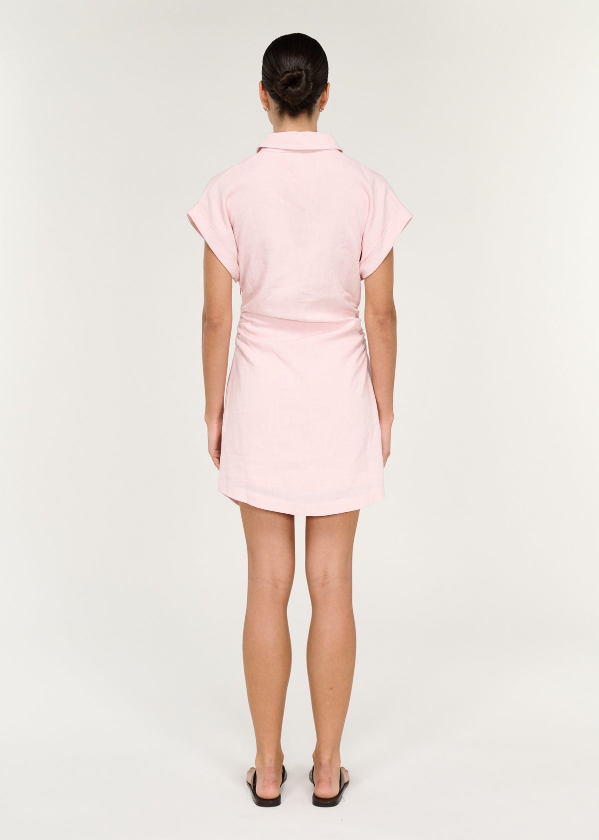 Back view of the Collared Mini Dress in Soft Pink with a lightweight woven fabrication and a soft blush pink hue.