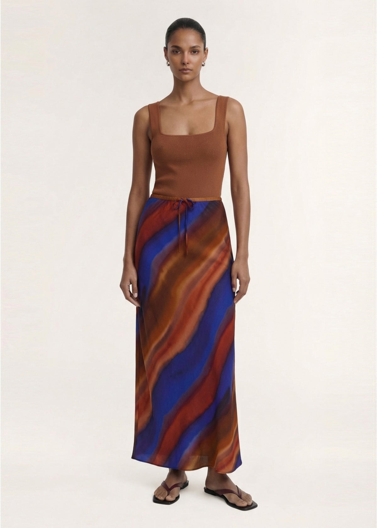 Model wearing Copper Square Neck Ribbed Knit Tank with a ribbed knit fabrication and a square neckline.