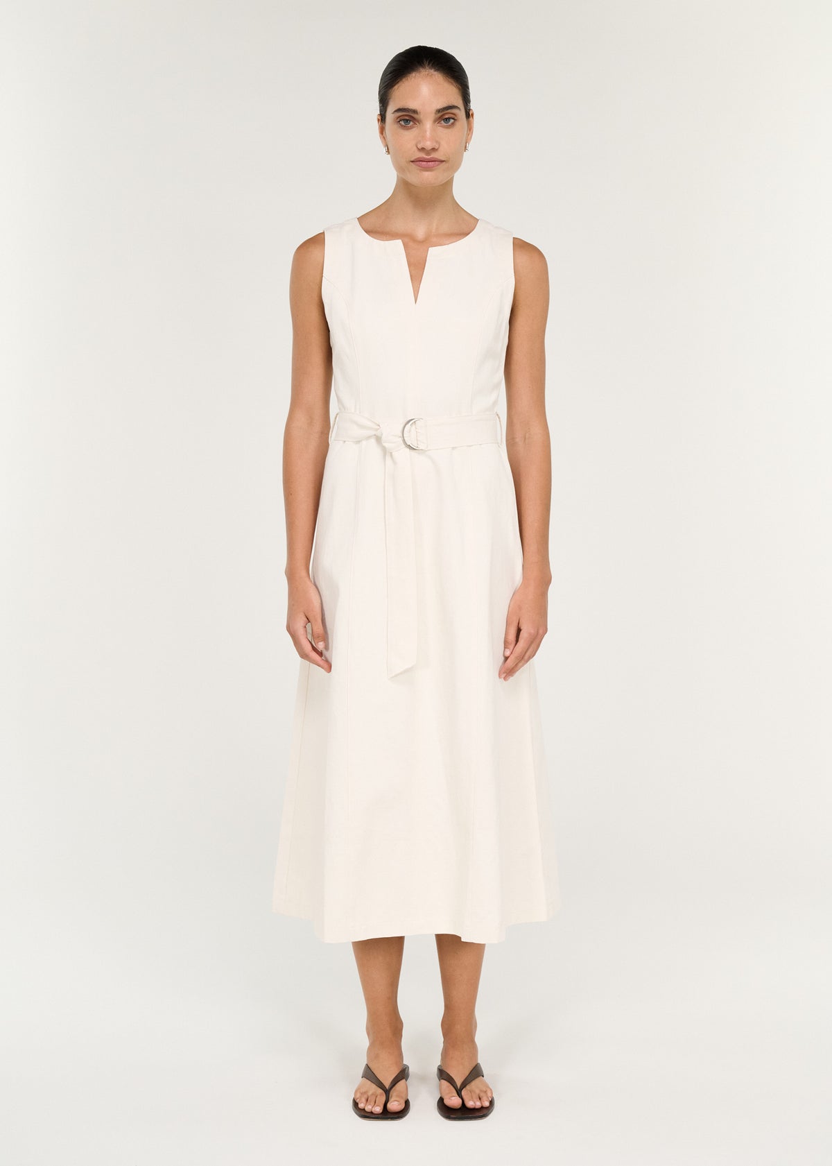 Model wearing Cotton Belted Wrap Midi Dress in Cream with a soft woven fabrication and a sleeveless silhouette.