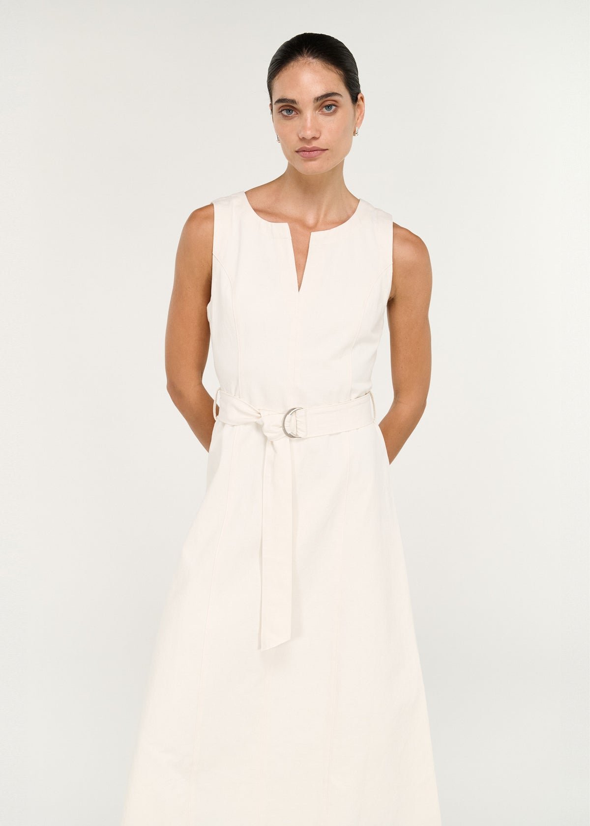Close-up of the Cotton Belted Wrap Midi Dress in Cream, showing a sleeveless silhouette and a split neckline.