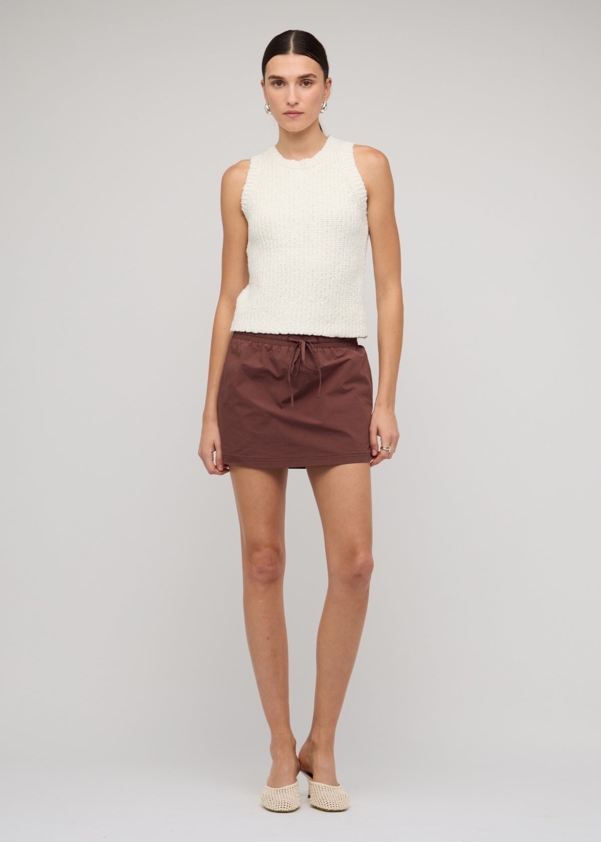 Model wearing Cotton-Blend Knit Tank Top In White, showing a textured knit finish and an ivory colour-way.
