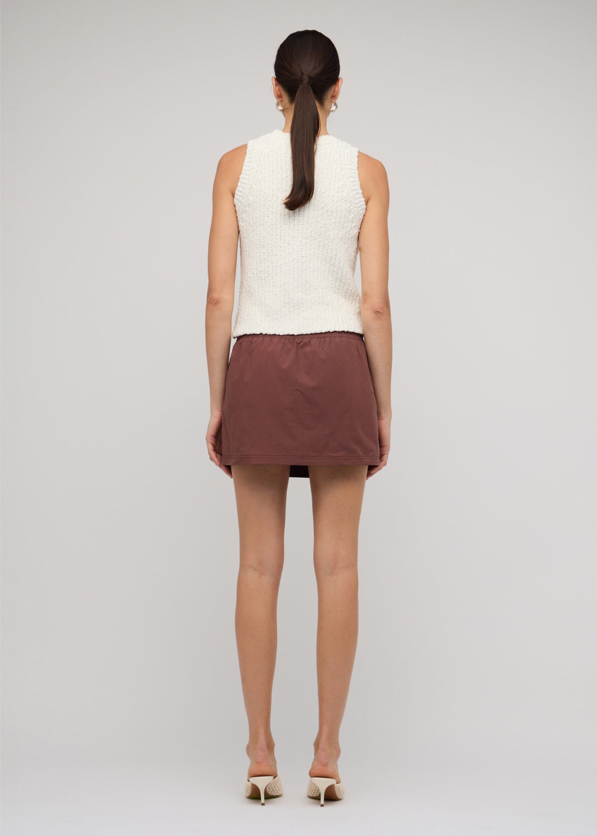 Back view of the Cotton-Blend Knit Tank Top In White with a sleeveless cut and a crew neckline.