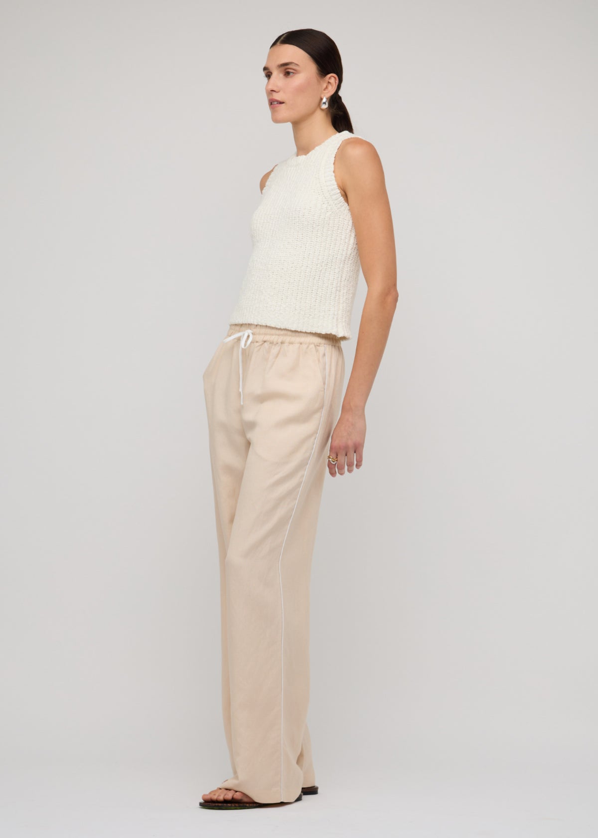 Side view of the Cotton-Blend Knit Tank Top In White, showing a sleeveless cut and a crew neckline.