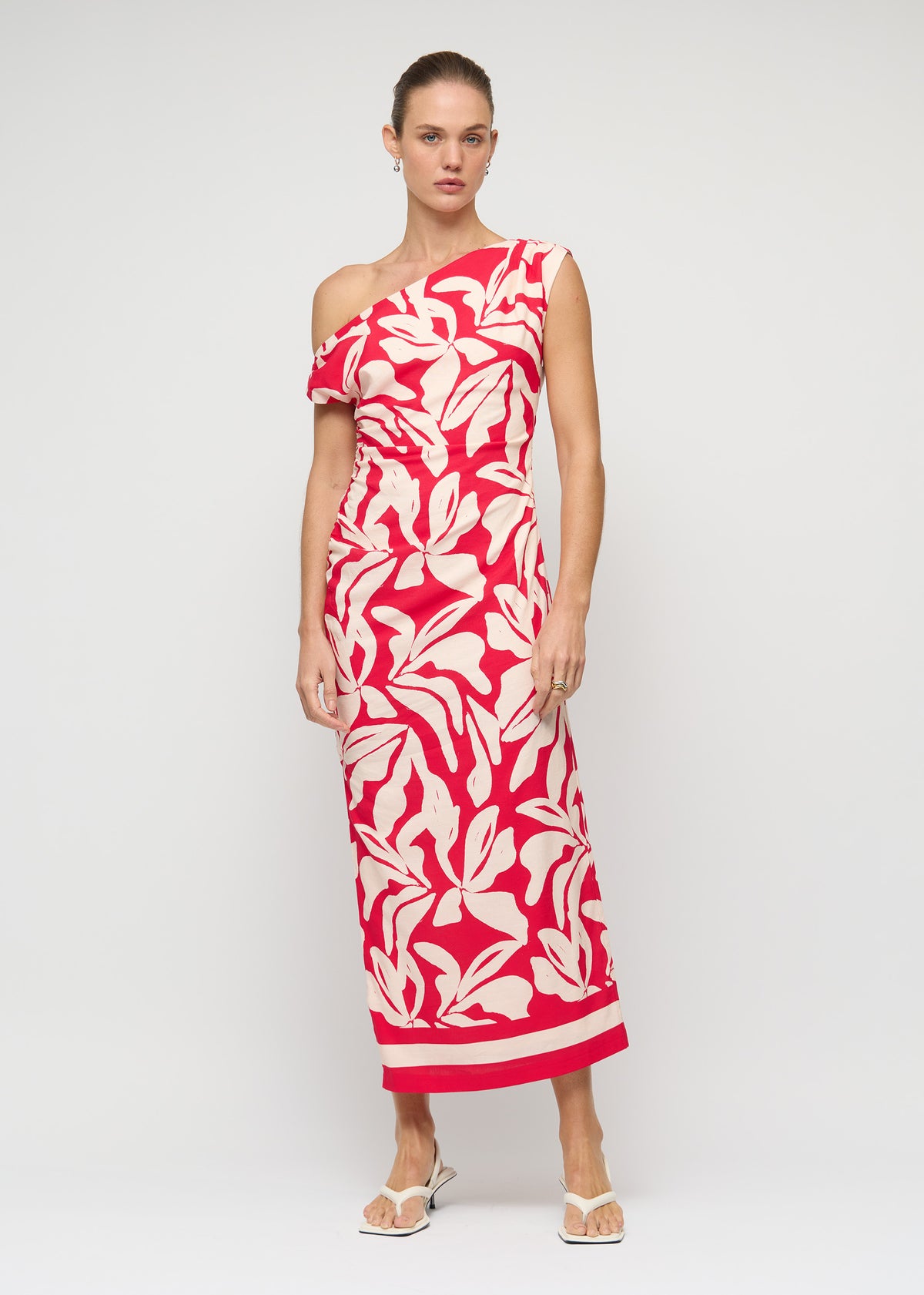 Model wearing Cotton Blend Red and White Floral Asymmetrical Midi Dress with an exclusive Staple the Label print.