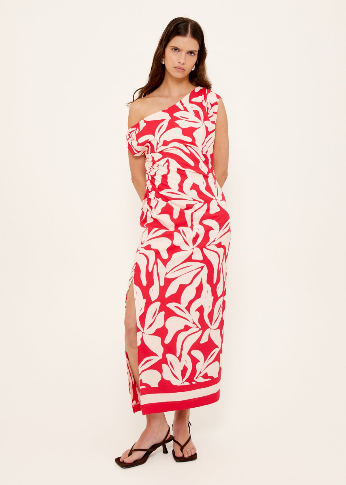 Model wearing Cotton Blend Red and White Floral Asymmetrical Midi Dress with a midi length and a fully lined.