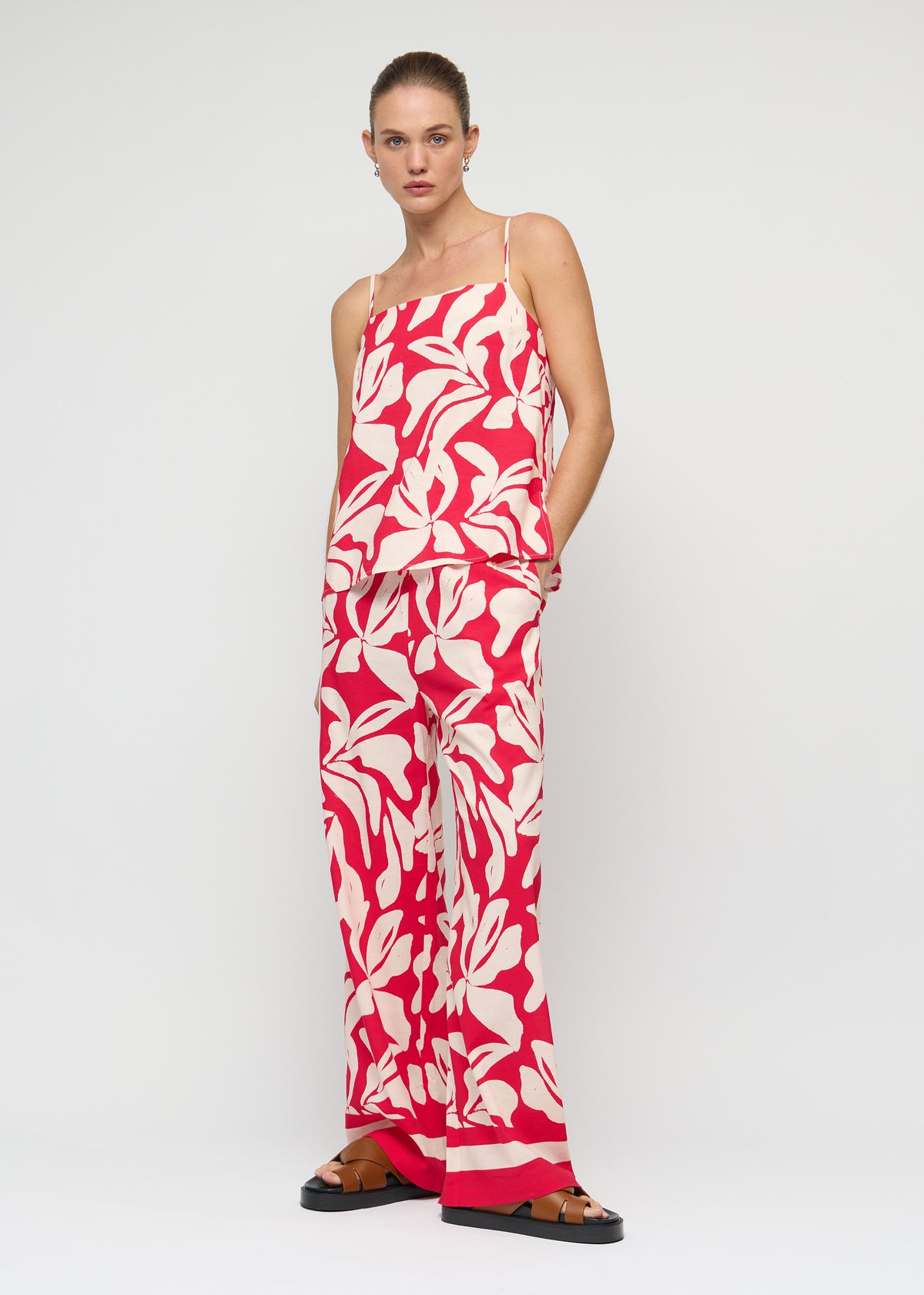 Model wearing Cotton Blend Red and White Floral Print Drawstring Pants with an exclusive Staple the Label print.