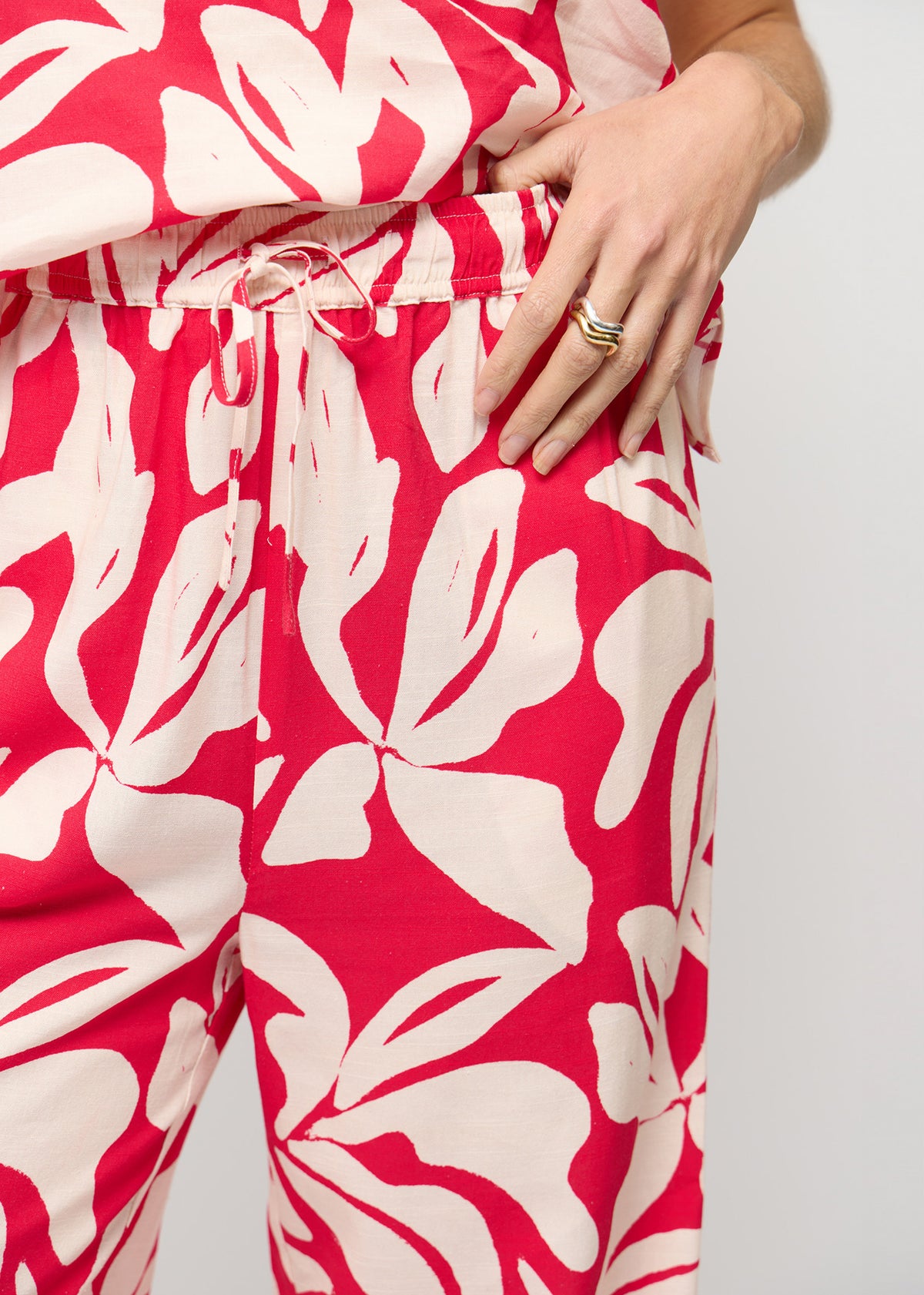 Close-up detail of the Cotton Blend Red and White Floral Print Drawstring Pants, showing drawstring waist.
