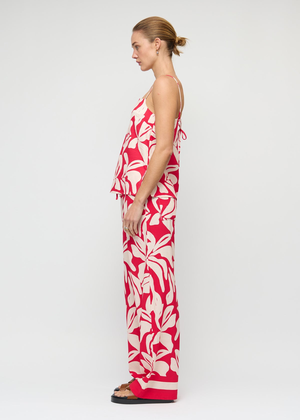 Side view of the Cotton Blend Red and White Floral Print Drawstring Pants, showing a full length and an exclusive Staple the Label print.