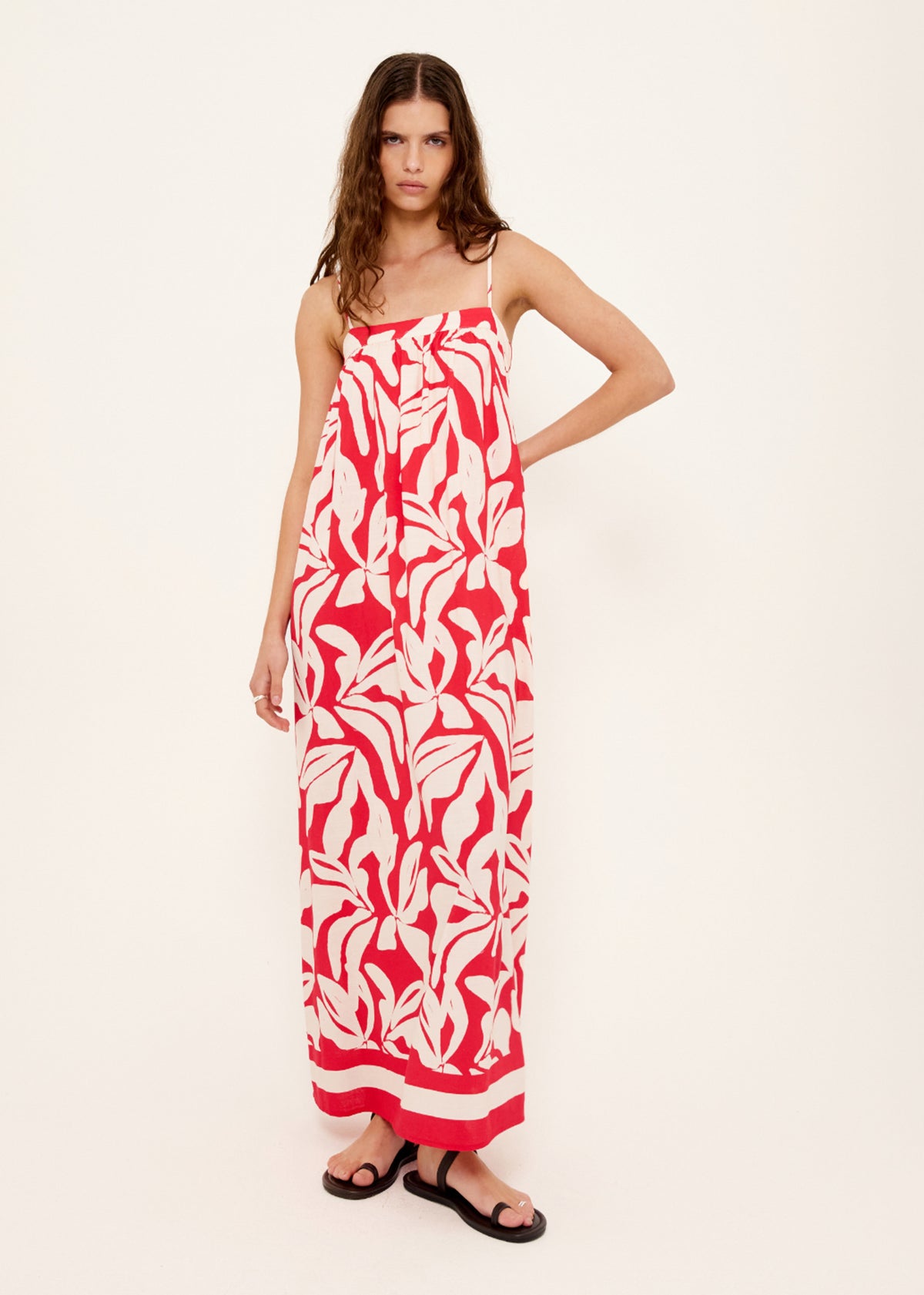 Model wearing Cotton Blend Red and White Floral Print Maxi Dress with an exclusive Staple the Label print and a relaxed, free-flowing fit.