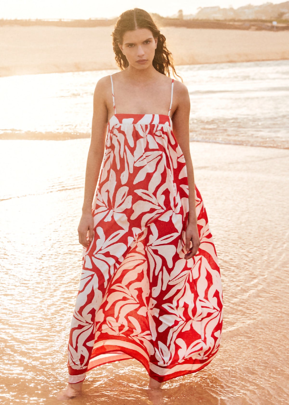 Model wearing Cotton Blend Red and White Floral Print Maxi Dress, showing adjustable tie-back straps and a square neckline.