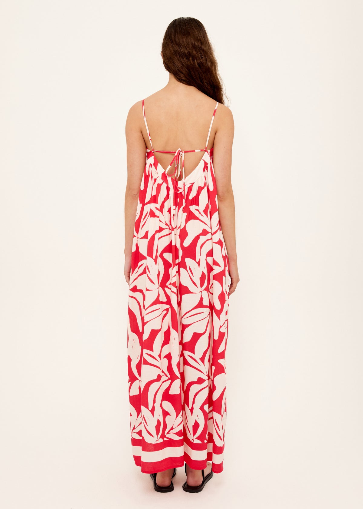 Back view of the Cotton Blend Red and White Floral Print Maxi Dress, showing adjustable tie-back straps.
