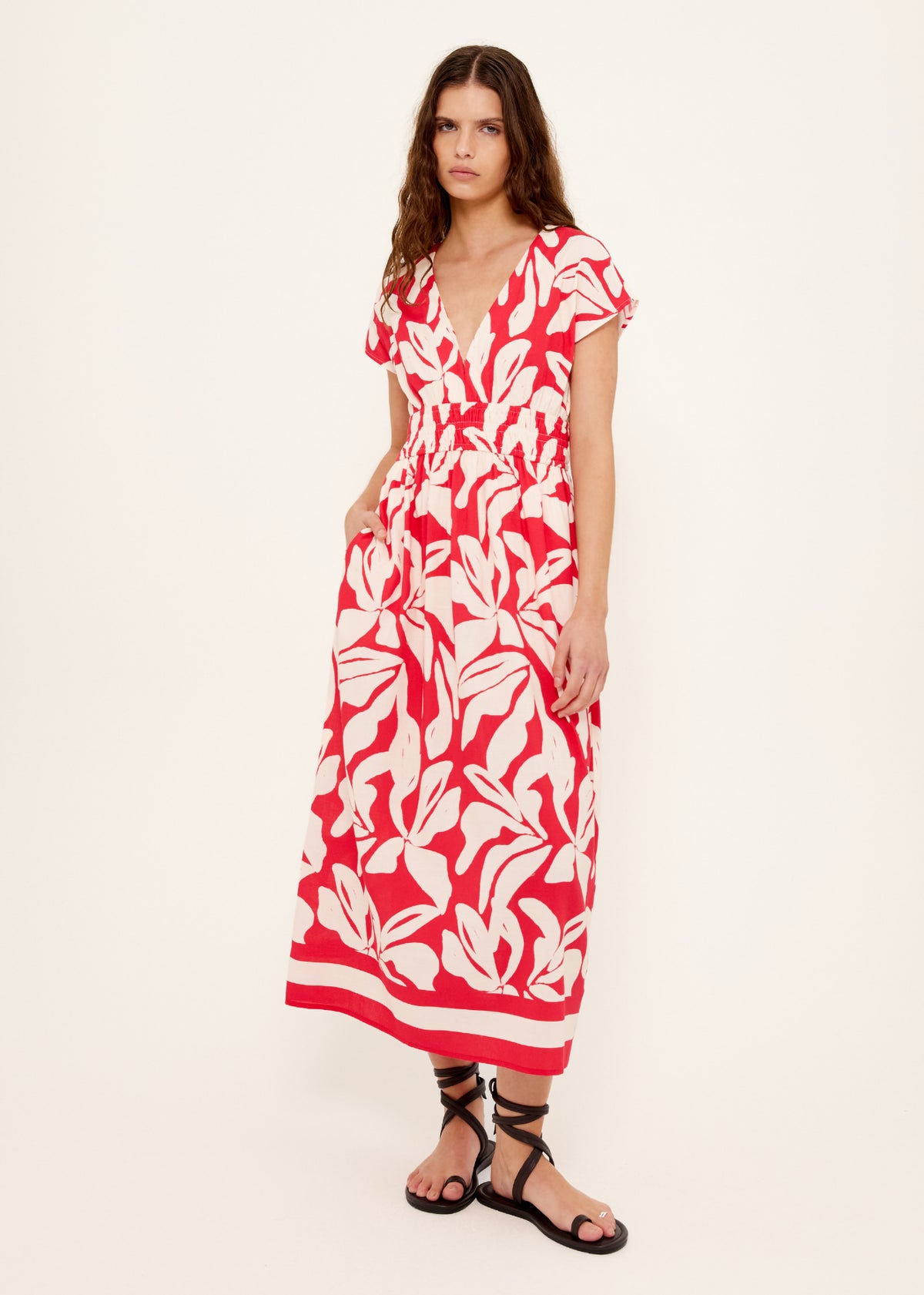 Model wearing Cotton Blend Red and White Floral Print Shirred Midi Dress with an exclusive Staple the Label print.