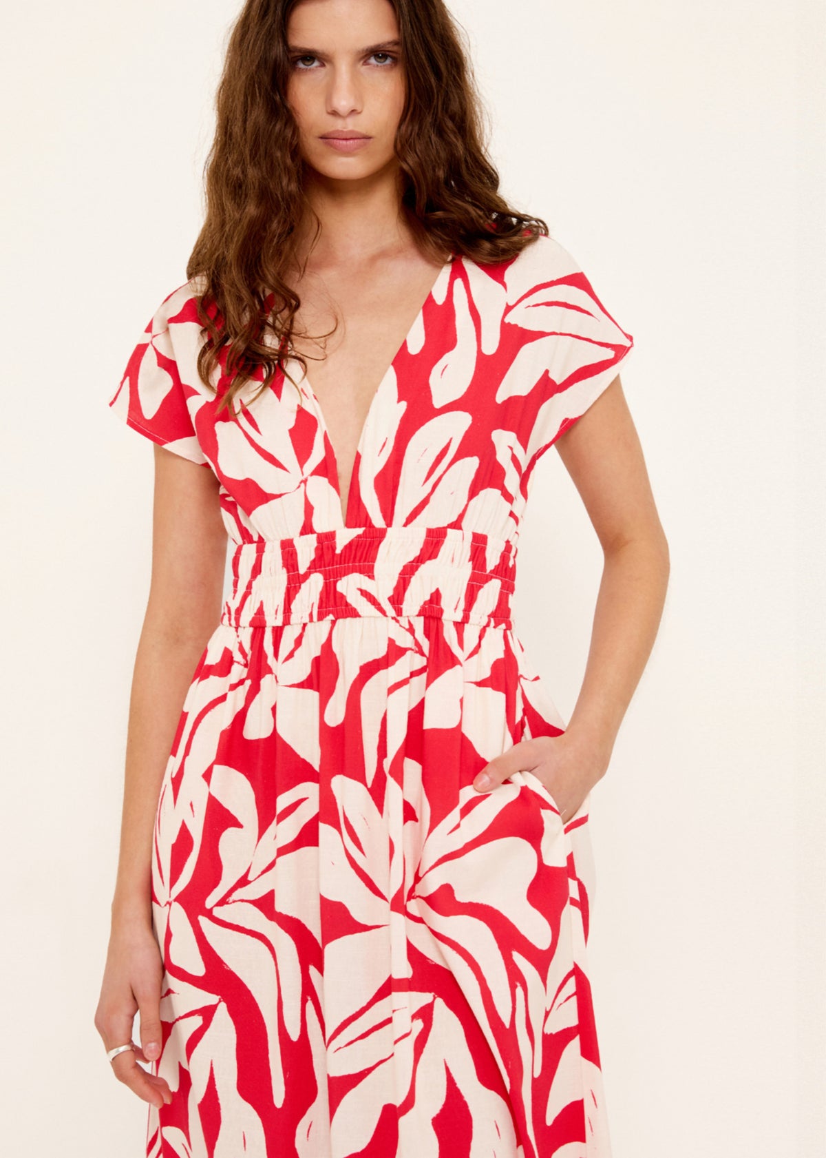 Close-up of the Cotton Blend Red and White Floral Print Shirred Midi Dress, showing deep V neckline with short flutter sleeves.