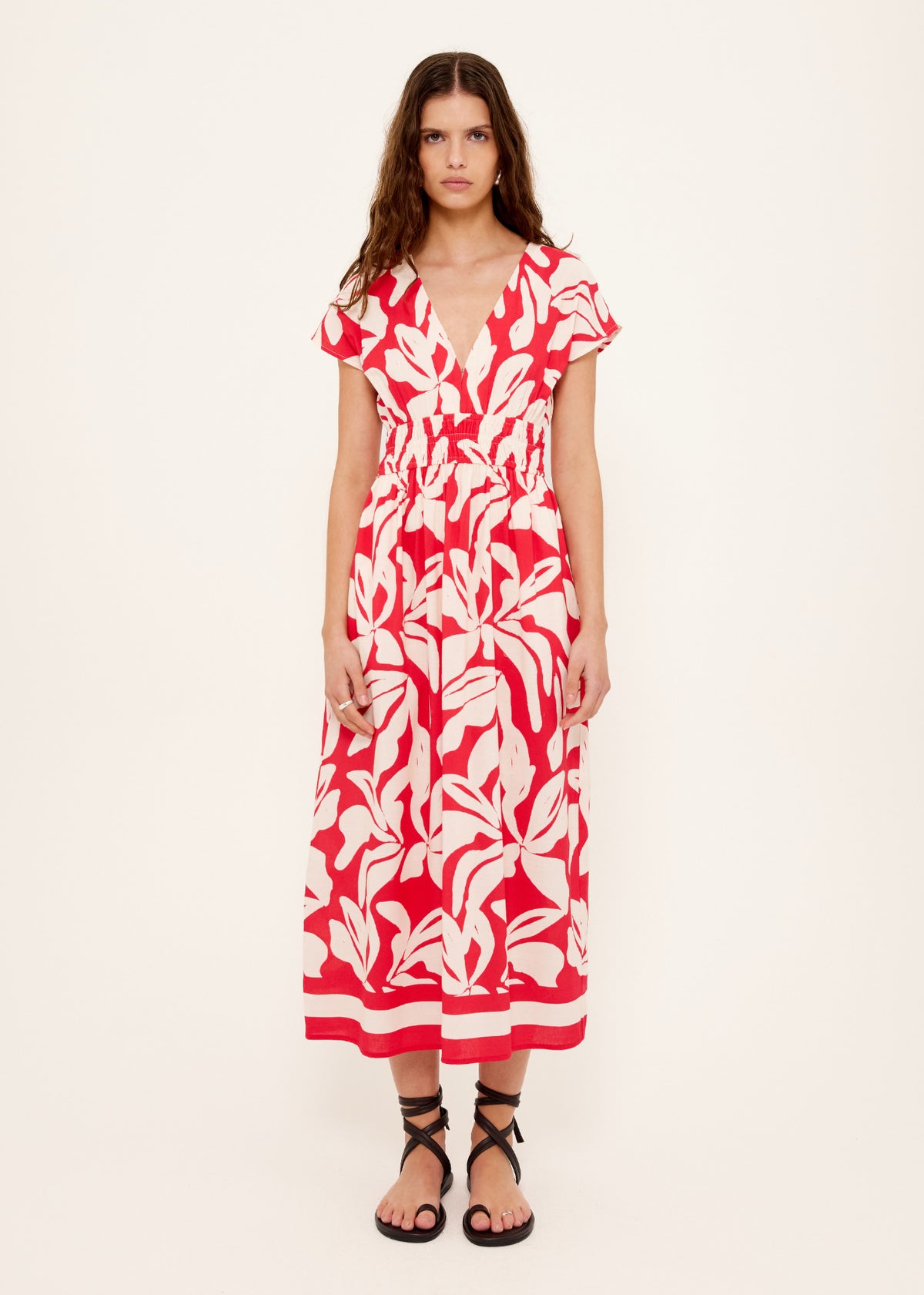 Model wearing Cotton Blend Red and White Floral Print Shirred Midi Dress, showing a midi length and an exclusive Staple the Label print.