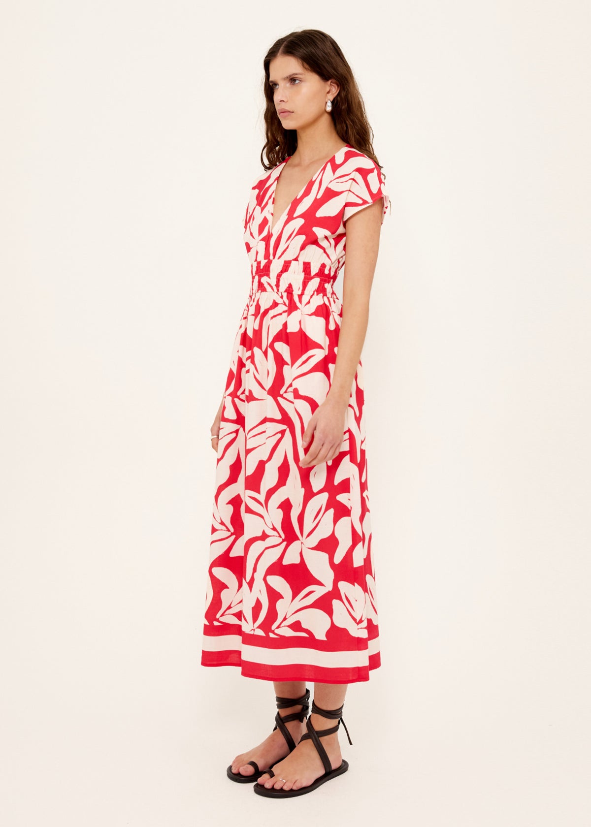 Side view of the Cotton Blend Red and White Floral Print Shirred Midi Dress, showing deep V neckline with short flutter sleeves.