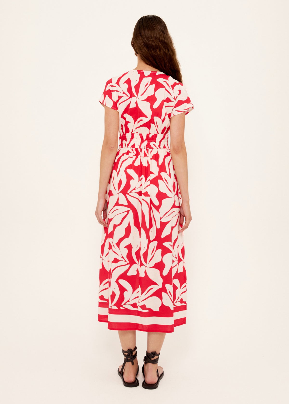 Back view of the Cotton Blend Red and White Floral Print Shirred Midi Dress with an exclusive Staple the Label print.