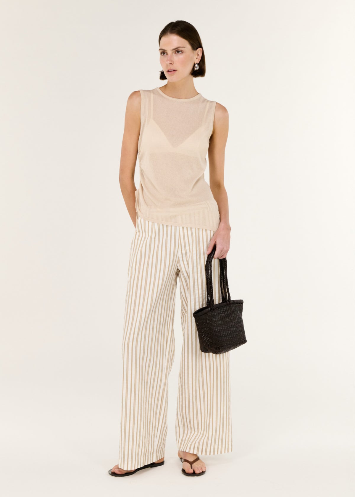 Model wearing Cotton Blend Stripe Mid-Rise Pants with a relaxed wide-leg fit.