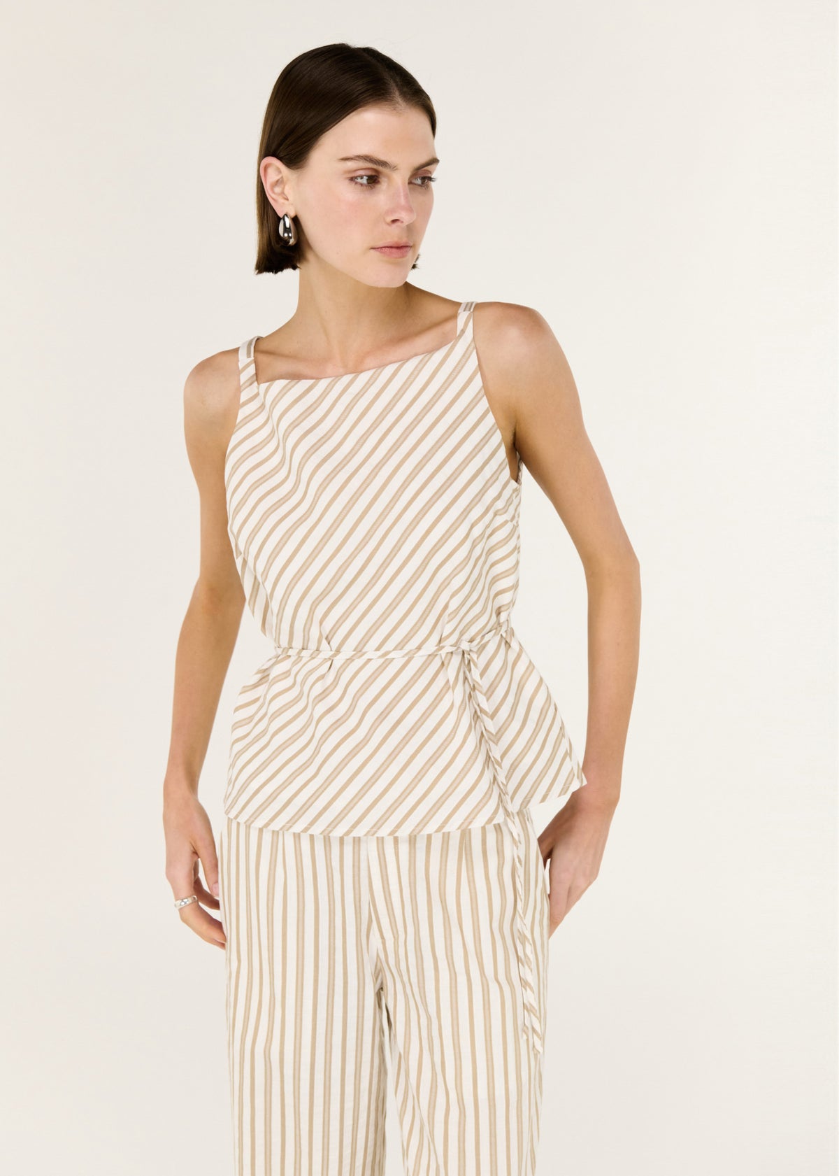Close-up of the Cotton Blend Stripe Tie Waist Top, showing a sleeveless cut and an adjustable tie waist.