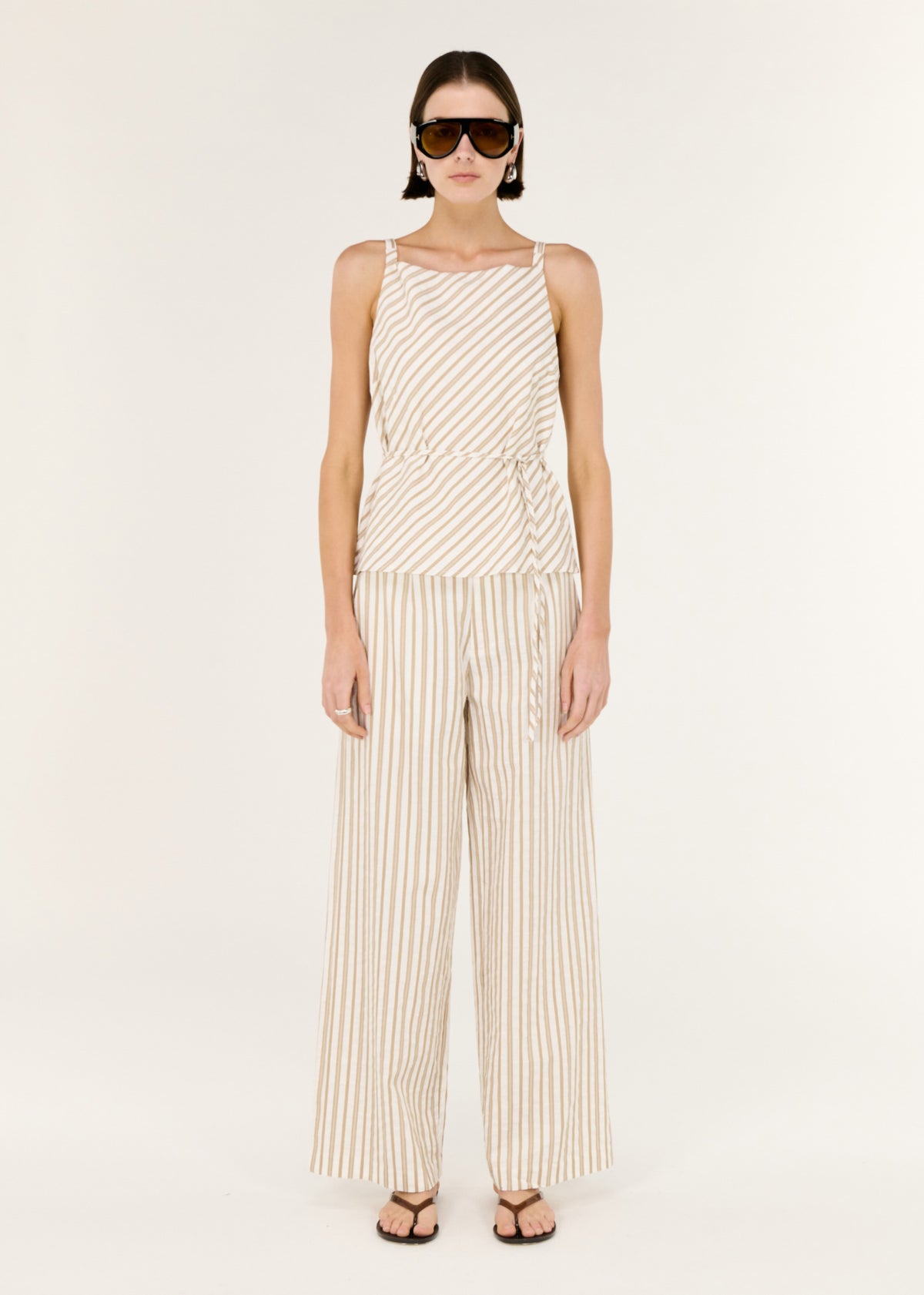 Model wearing Cotton Blend Stripe Tie Waist Top with a soft taupe and white stripe design.
