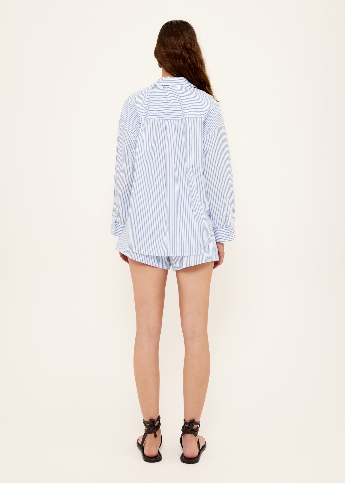 Back view of the Cotton Blue and White Oversized Shirt with a button-through front and an oversized fit.