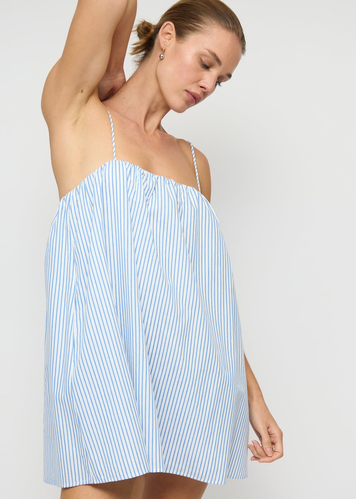 Close-up of the Cotton Blue and White Stripe Mini Dress, showing adjustable tie-back straps and a straight neckline.
