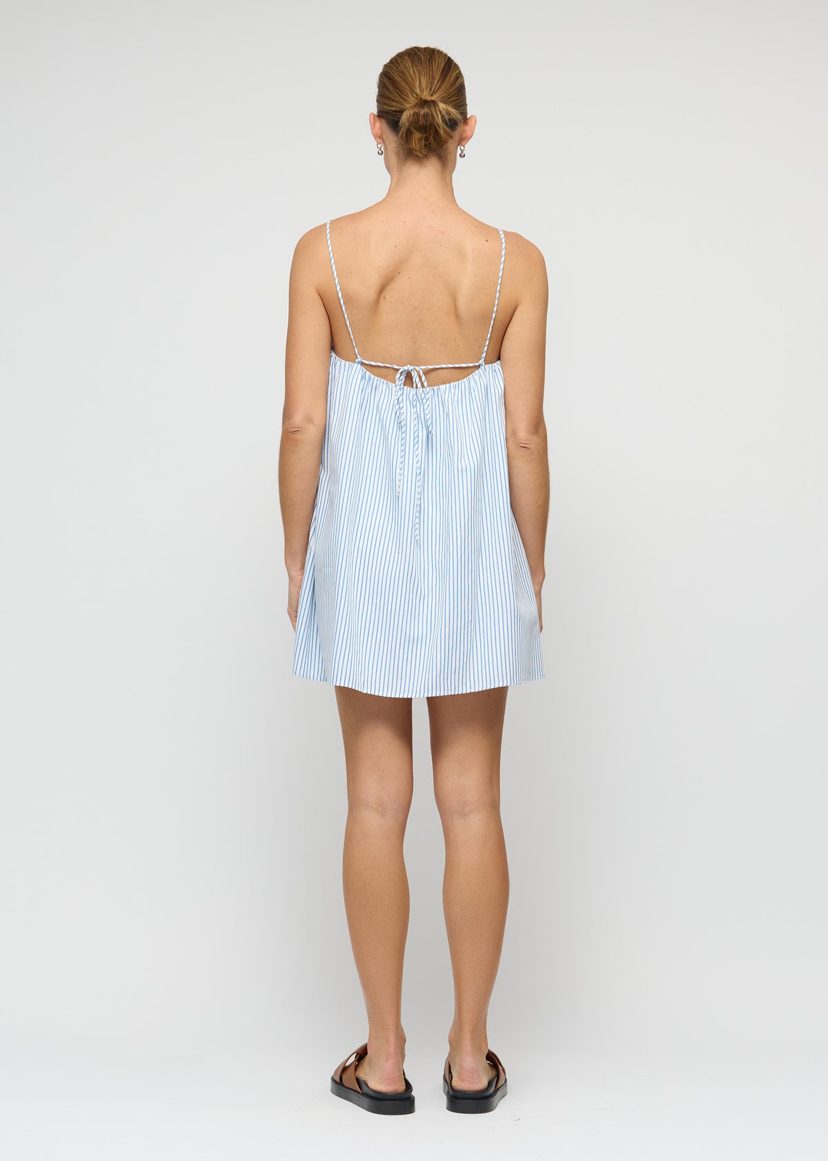 Back view of the Cotton Blue and White Stripe Mini Dress with adjustable tie-back straps.