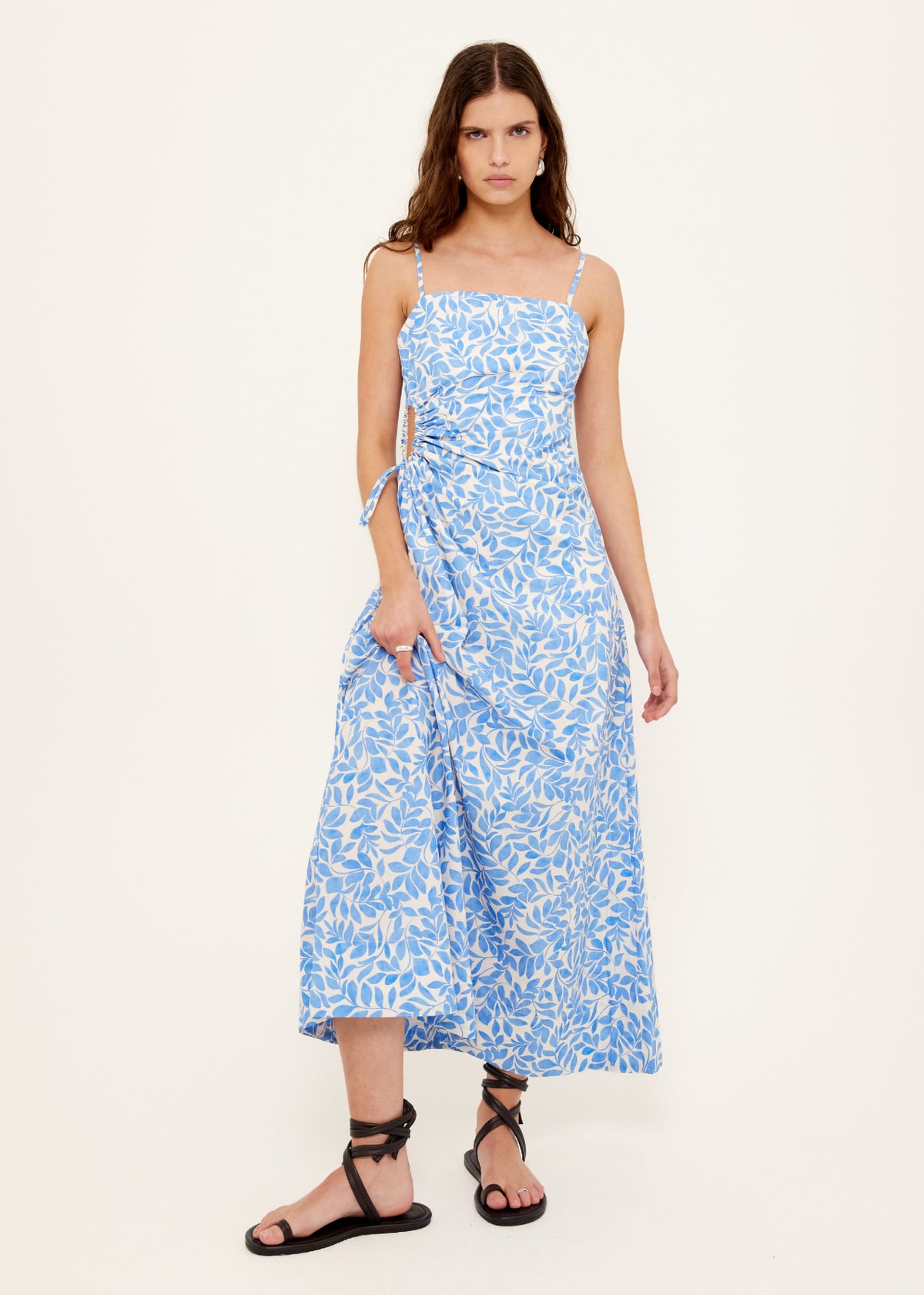 Model wearing Cotton Blue Leaf Print Cut Out Maxi Dress, showing an exclusive blue and ivory print.