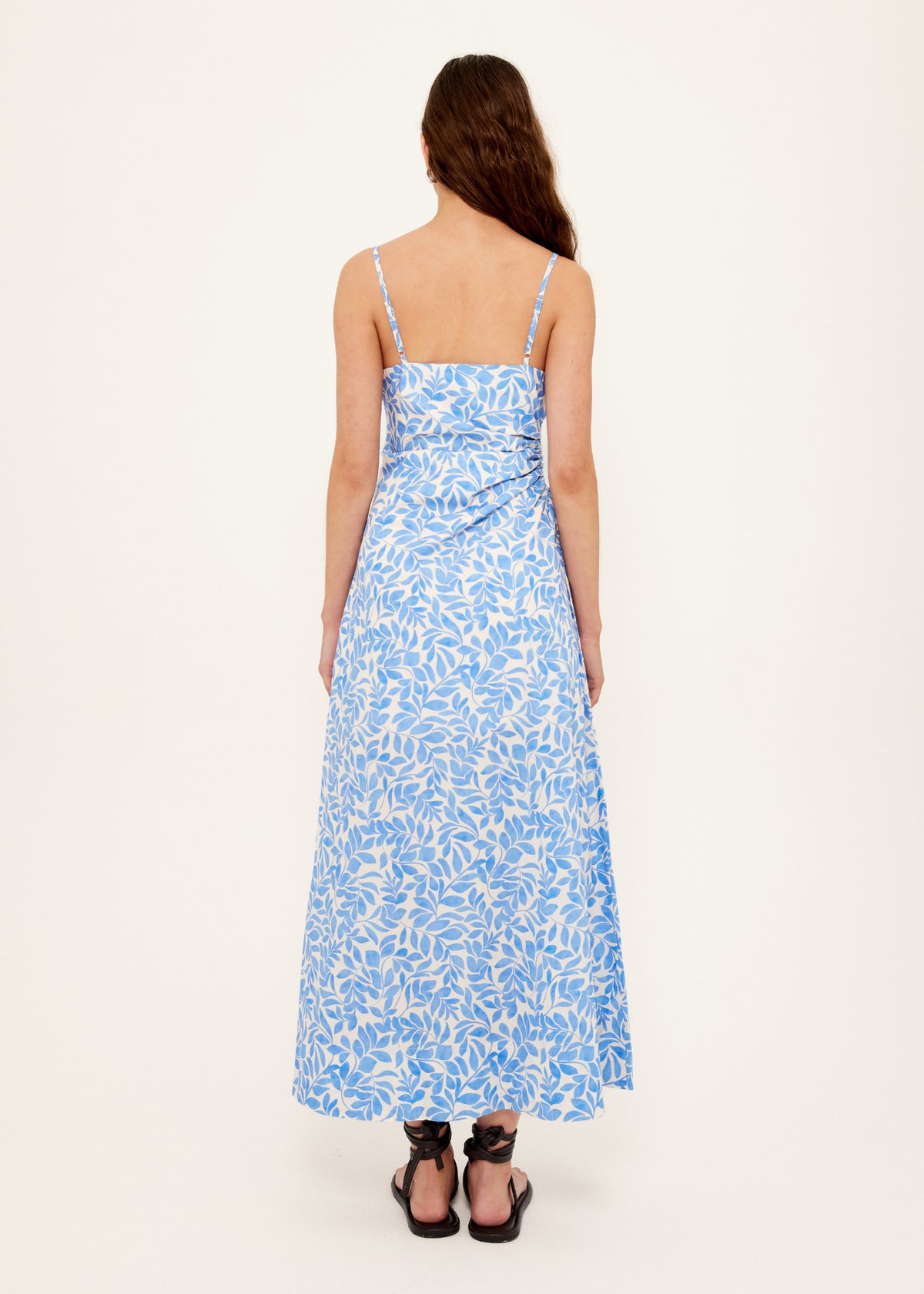 Back view of the Cotton Blue Leaf Print Cut Out Maxi Dress with square neckline with adjustable straps.