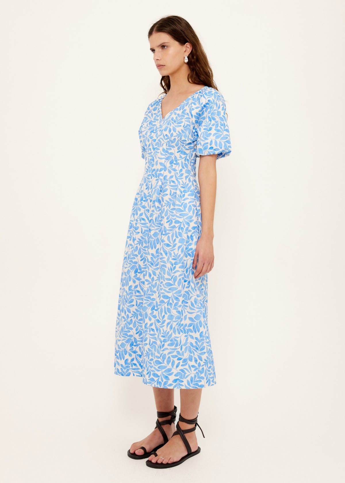 Side view of the Cotton Blue Leaf Print V-neck Midi Dress, showing an exclusive blue and ivory print.