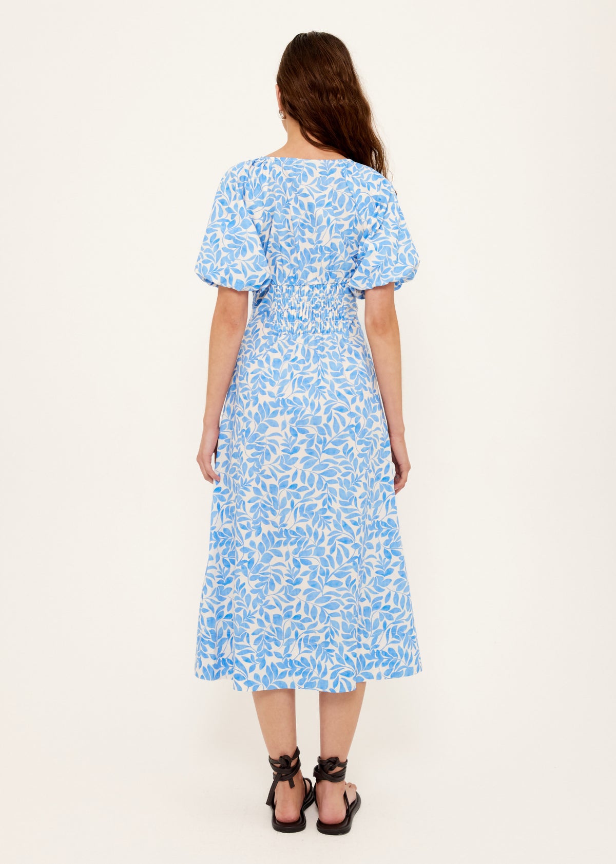 Back view of the Cotton Blue Leaf Print V-neck Midi Dress with a v-neckline with gathered bust seam.