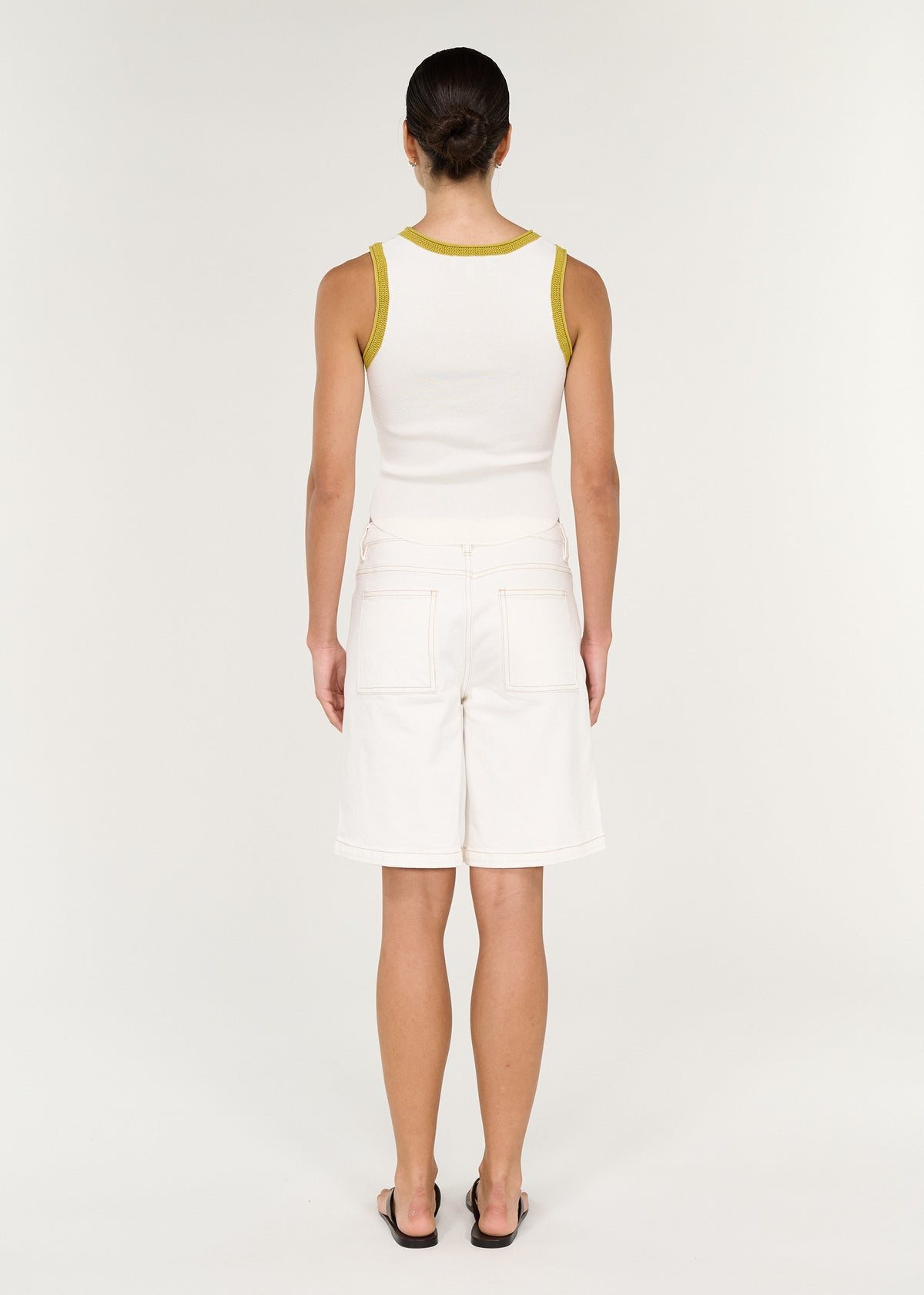 Back view of the Cotton Denim Mid Rise Jorts in White with a front zip and button closure.