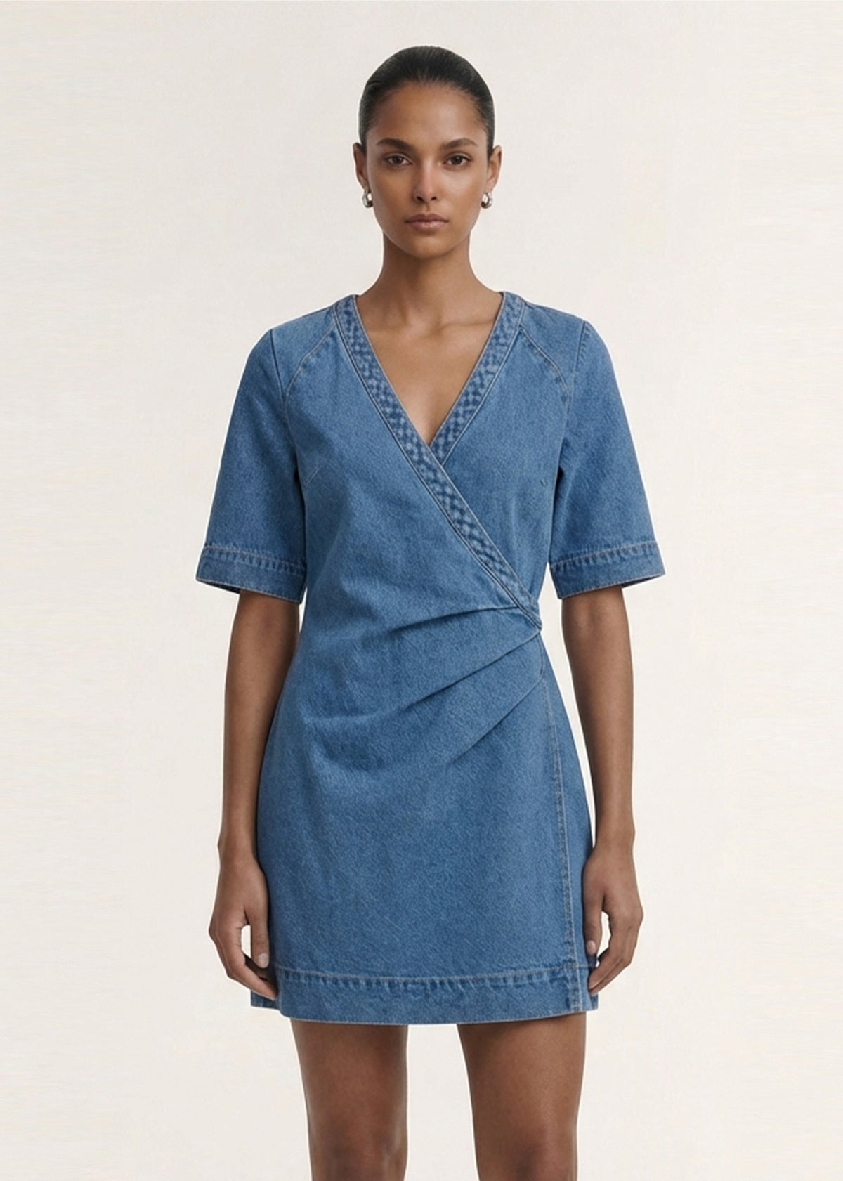 Close-up of the Cotton Denim Wrap Detail Mini Dress, showing a wrap-style bodice detail and a deep V-neckline.