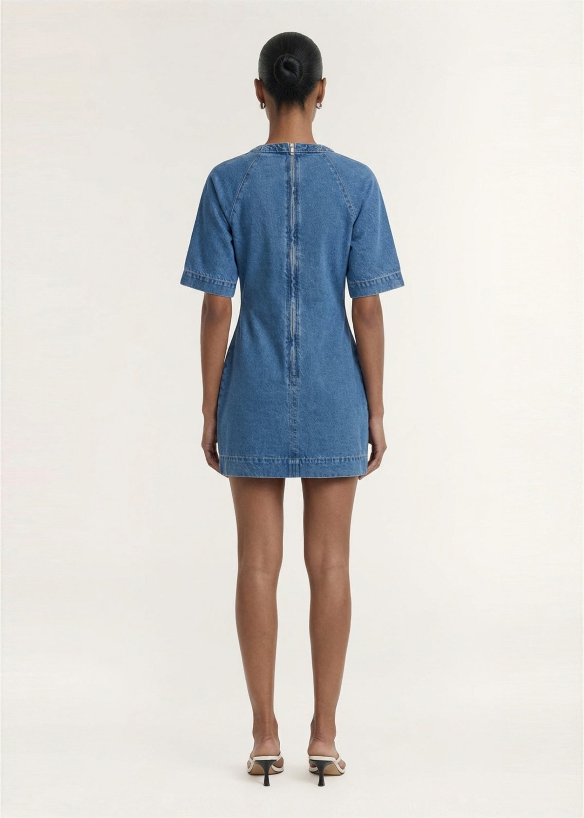 Back view of the Cotton Denim Wrap Detail Mini Dress, showing a back zip closure and a soft mid-wash denim fabrication.