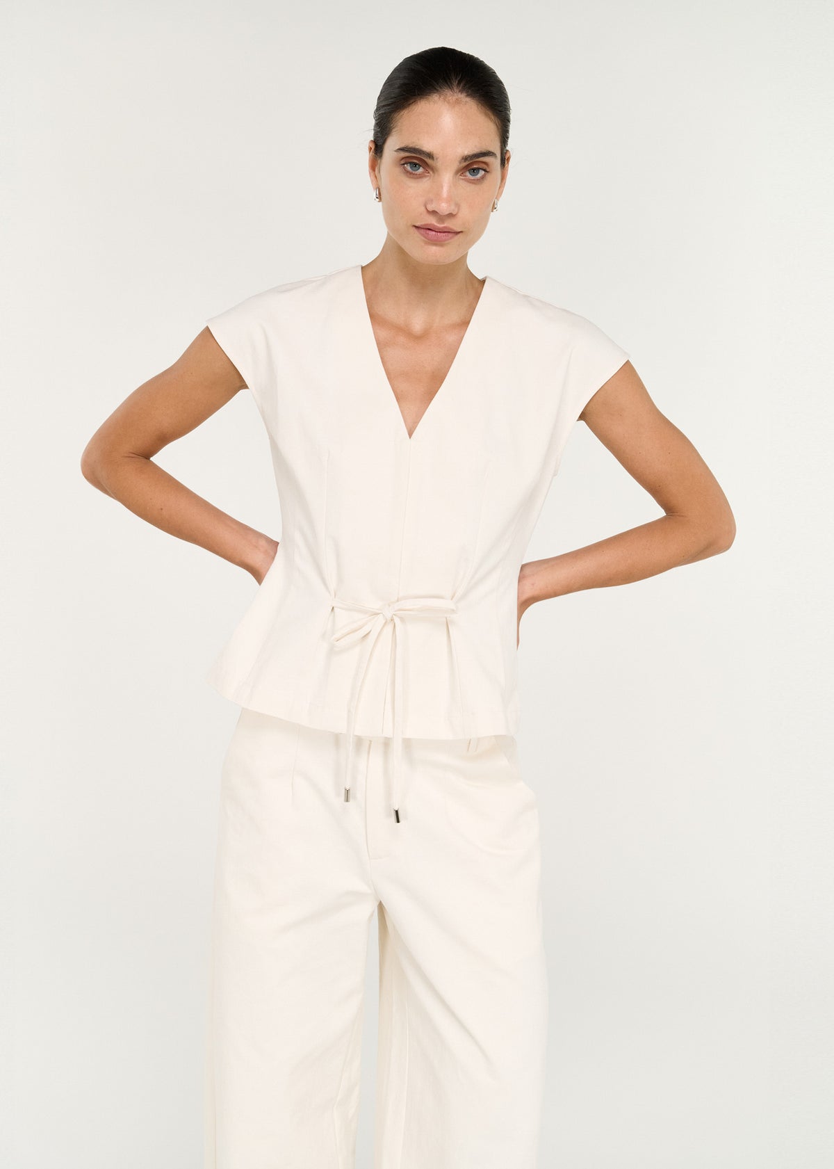 Close-up of the Cotton Tie Front Top with Cap Sleeve, showing a v-neckline and extended cap sleeves.